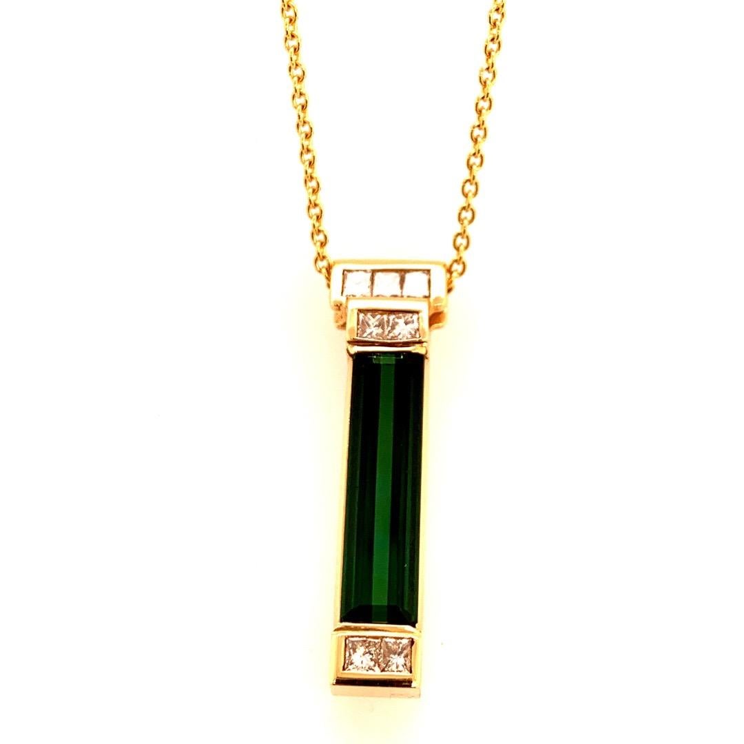 Modern 18k Yellow Gold APPROXIMATELY 7 Carat Natural Green Tourmaline & Diamond Gemstone Pendant. 

The Deep Green centerstone is a Natural Tourmaline measuring 23.5x6x4.5mm. The approximate weight is 5.75 carat. 

The pendant is also set with 7