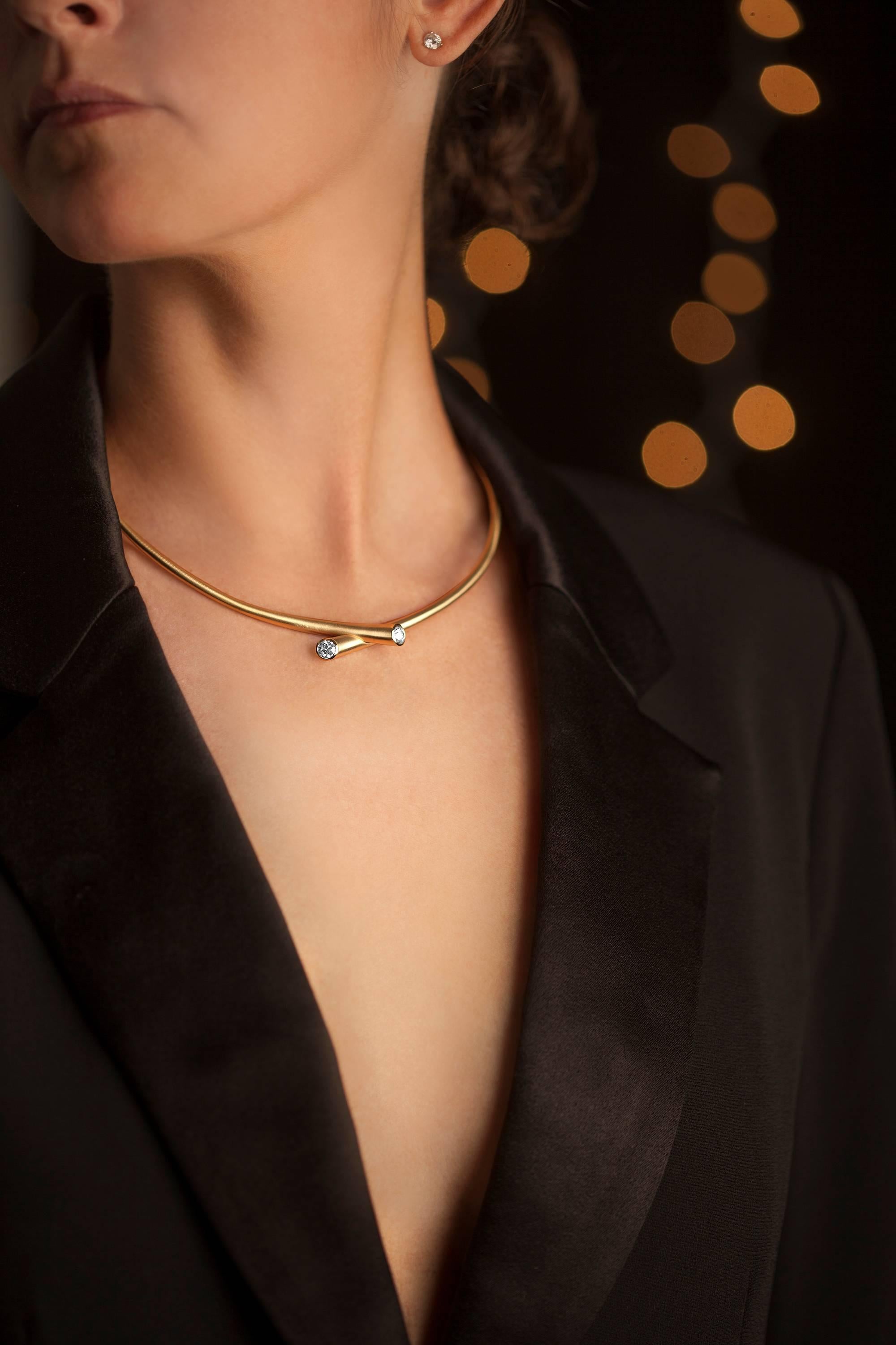 This solid 18 karat yellow gold collar necklace showcases two round diamonds totaling .88 carats of GH-VS diamonds, exuding a style both iconic and effortlessly chic.  The hinged back opening with click figure-eight safety closure is easy to put on