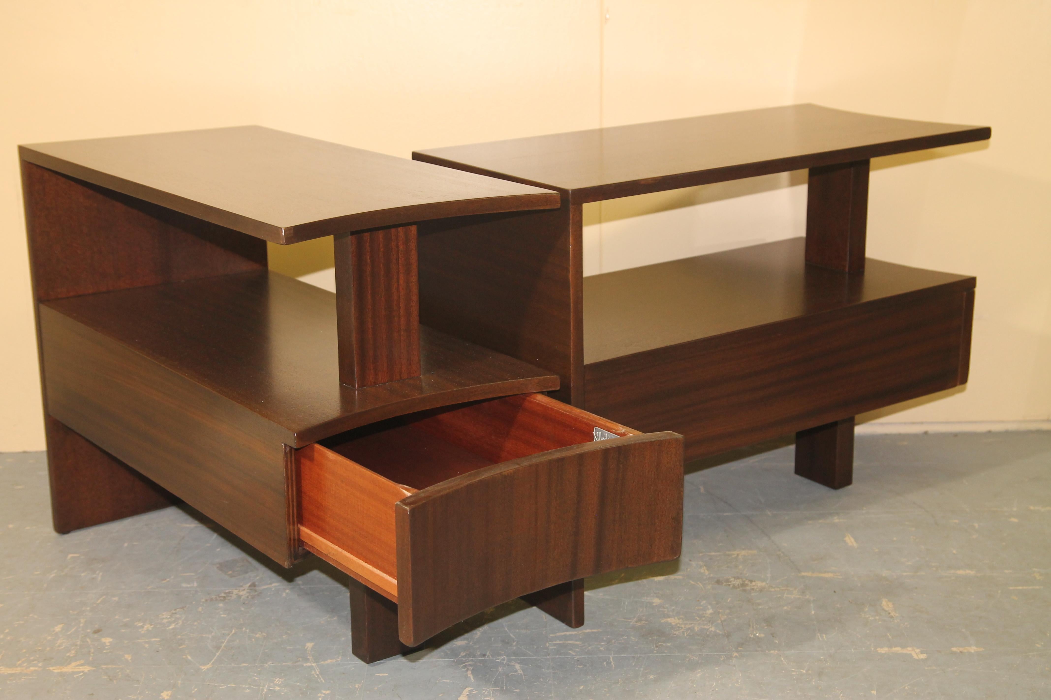 Pictures do not do these amazing and rare African Mahogany side tables from Modernage justice. I have had these beautiful tables restored and it is a design that I have not seen for sale on this or any other sites. You need to see these simple