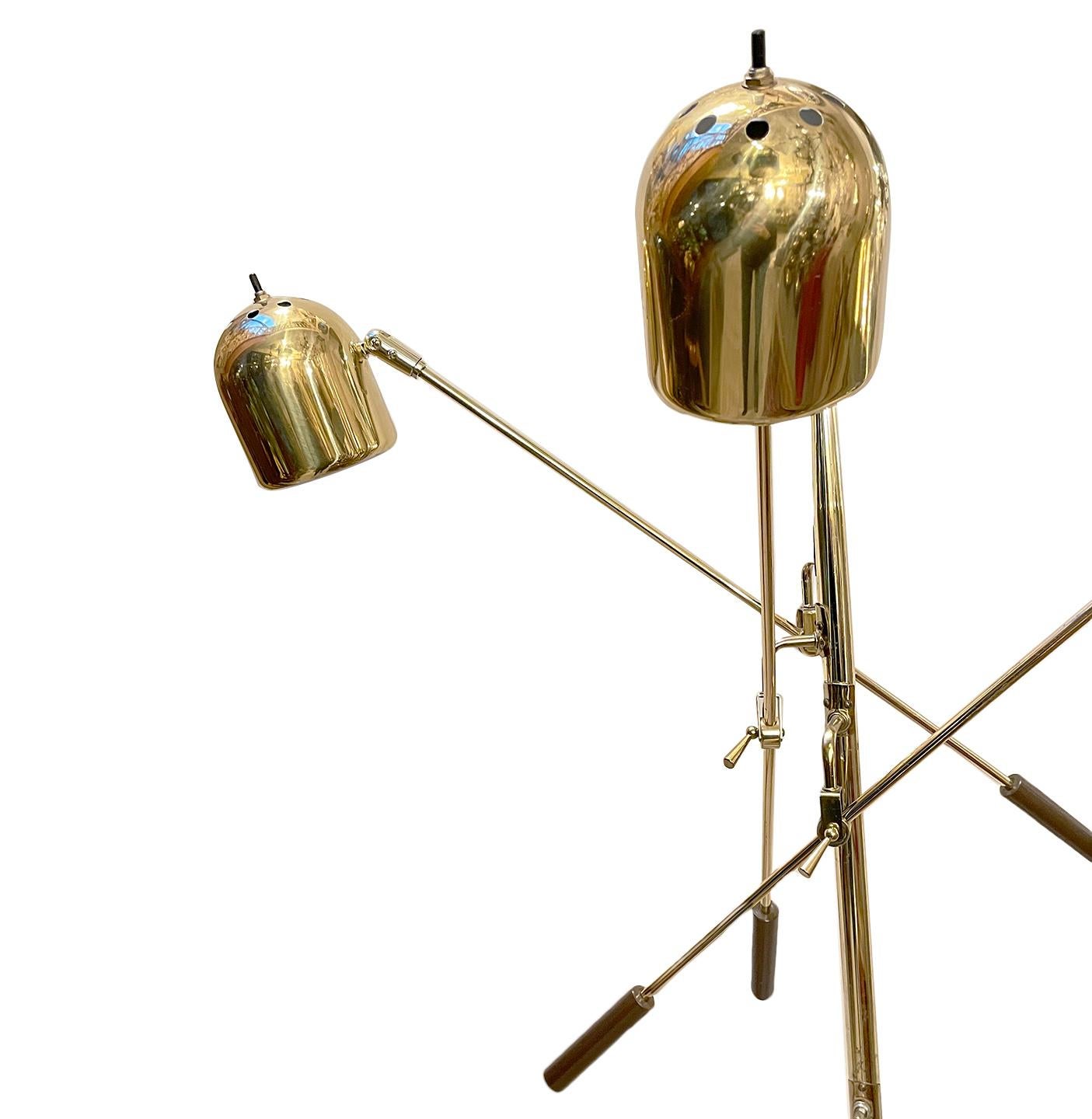 A circa 1960's Italian moderne brass floor lamp with swivel shades and white marble base and original finish.

Measurements:
Height: 60.5