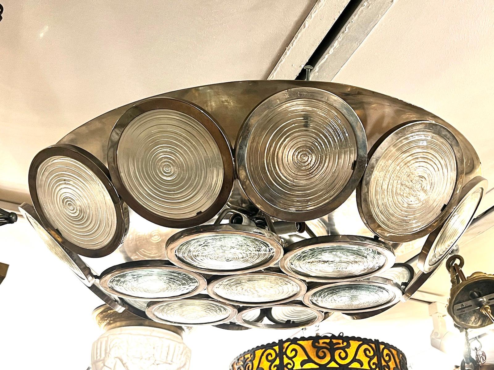 A circa 1960's Italian moderne style nickel-plated flush mount fixture with six interior lights.

Measurements:
Drop: 6