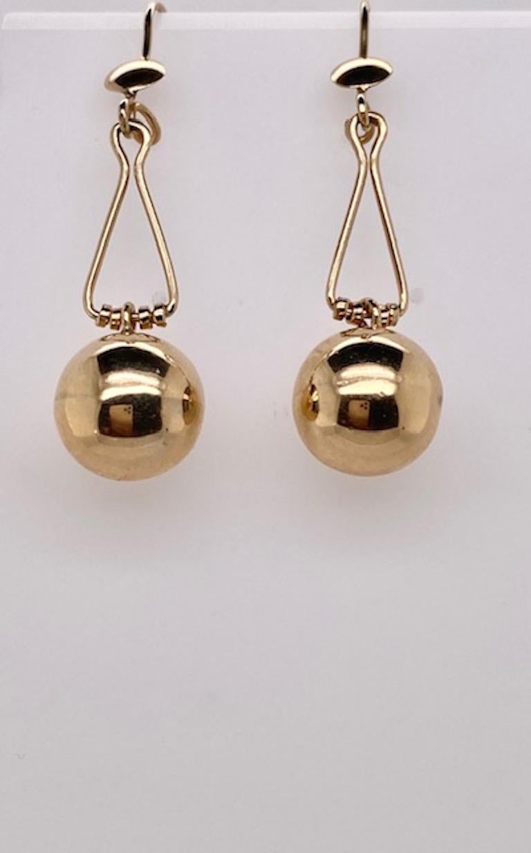 Chic moderne drop earrings.  Small ball on top, suspending a larger ball.  14K yellow gold.  2