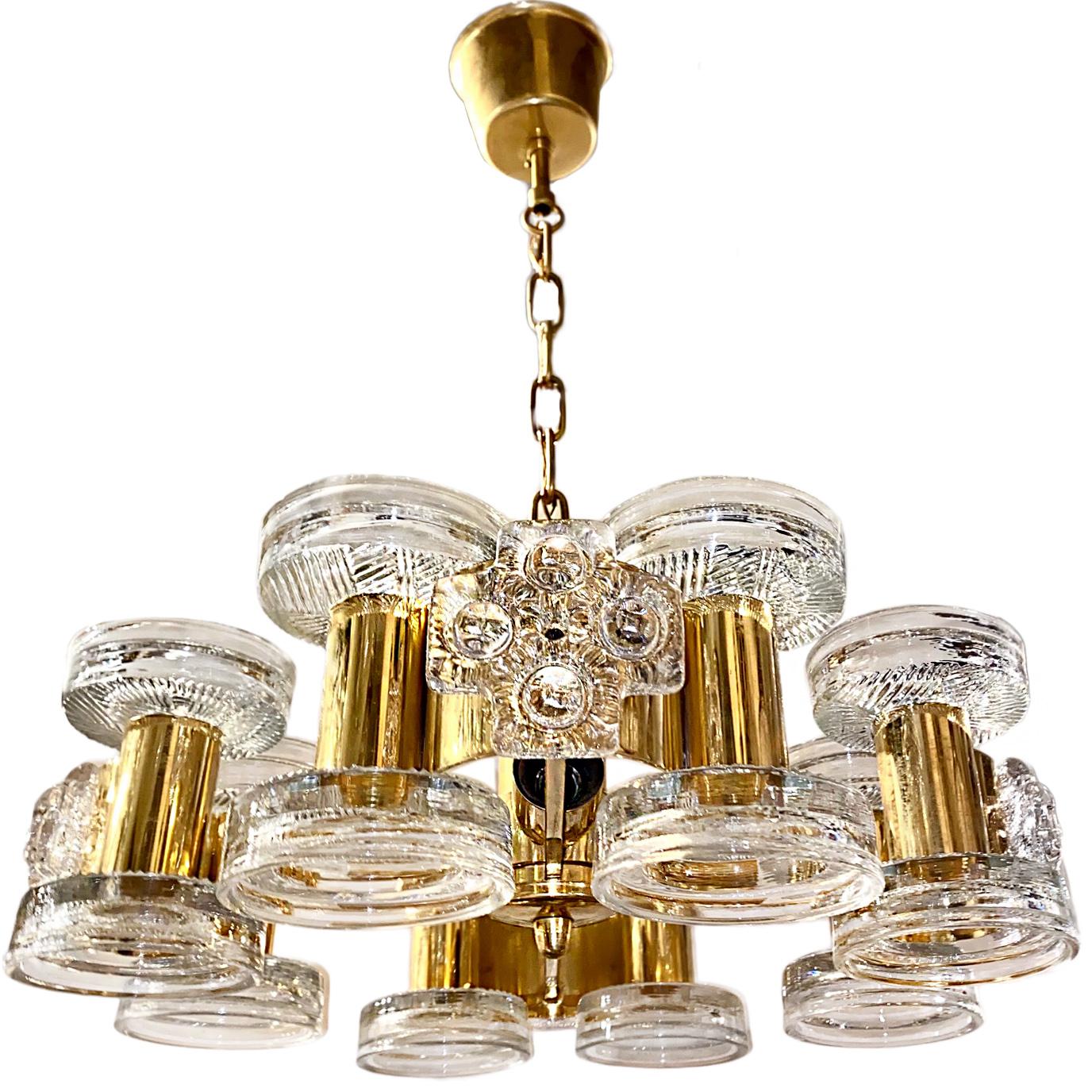 A Swedish moderne glass and bronze chandelier with interior lights, circa 1960s. Molded glass pieces insets throughout the body.
Pristine condition, rewired.

Measurements:
15.75