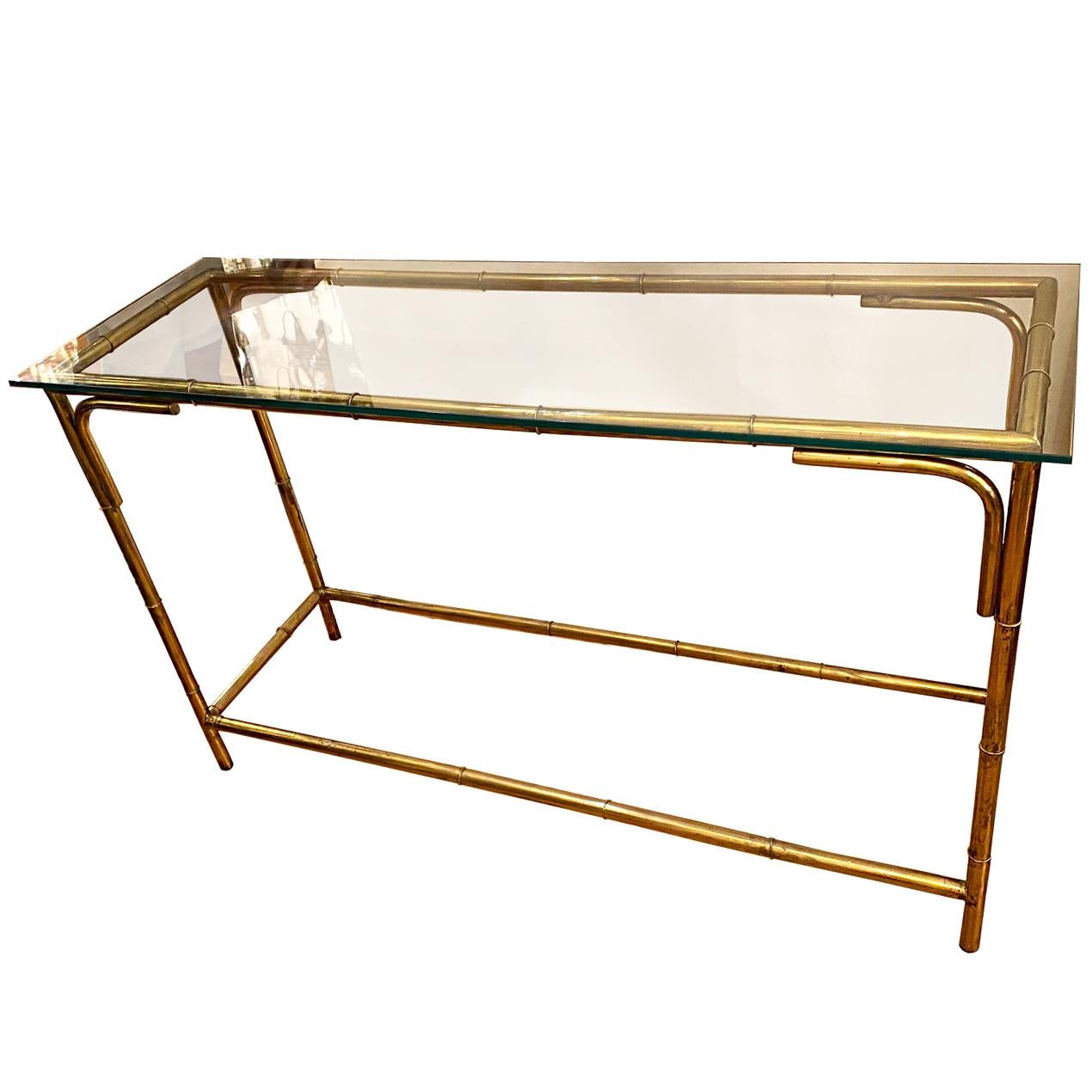 A circa 1960s Italian brass console table with glass top.

Measurements:
Height 32