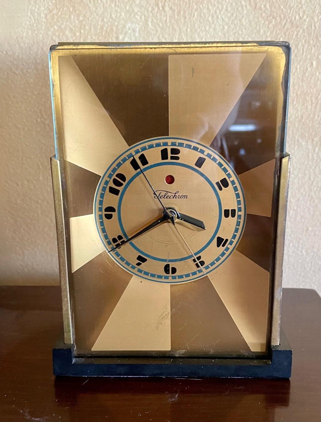 Art Deco Skyscraper Warren Telechron Clock 431Modernique by Paul Frankl, 1928. This very rare two-tone gold model with a bakelite base and rear panel includes a blue chapter ring dial with a black logo and numbers. The standard M1 rotor movement