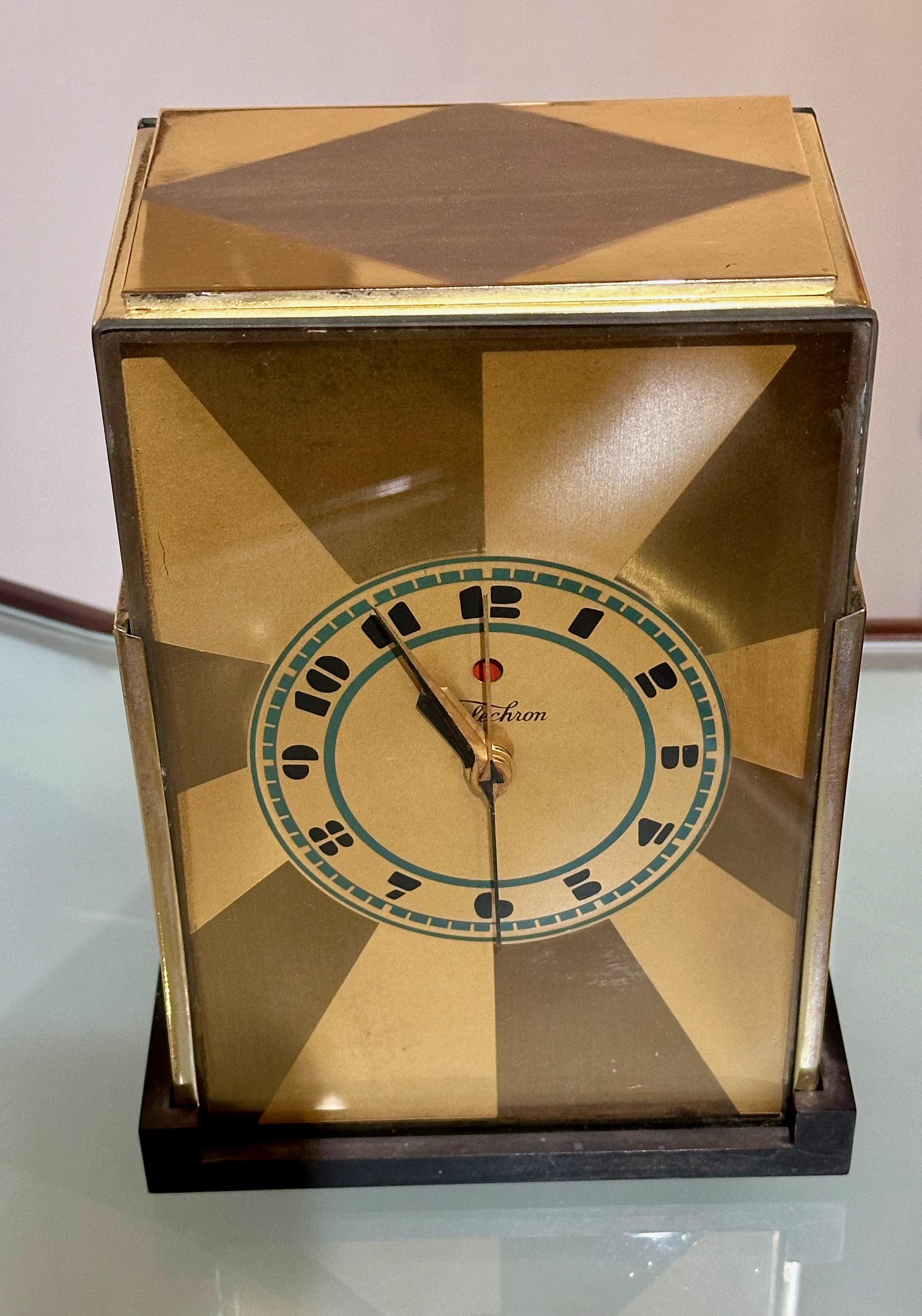 Art Deco Skyscraper Warren Telechron Clock 431Modernique by Paul Frankl, 1928. This very rare two-tone gold model with a bakelite base and rear panel includes a blue chapter ring dial with a black logo and numbers. This radio has just been recently