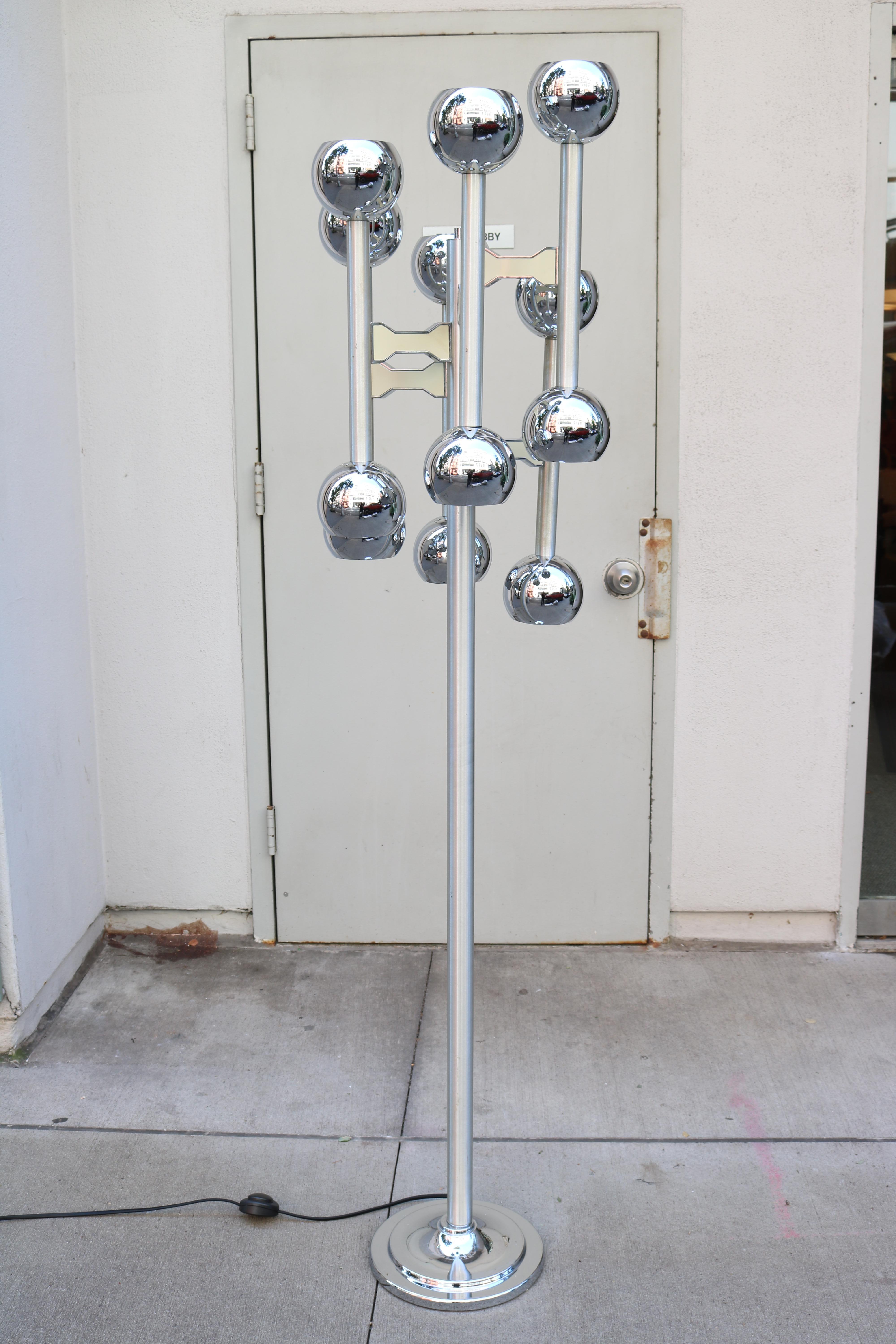 Modernist twelve light floor lamp. 
Chrome plated with six protruding arms with 
an up and down light on each arm. Mounted 
on a round base.
