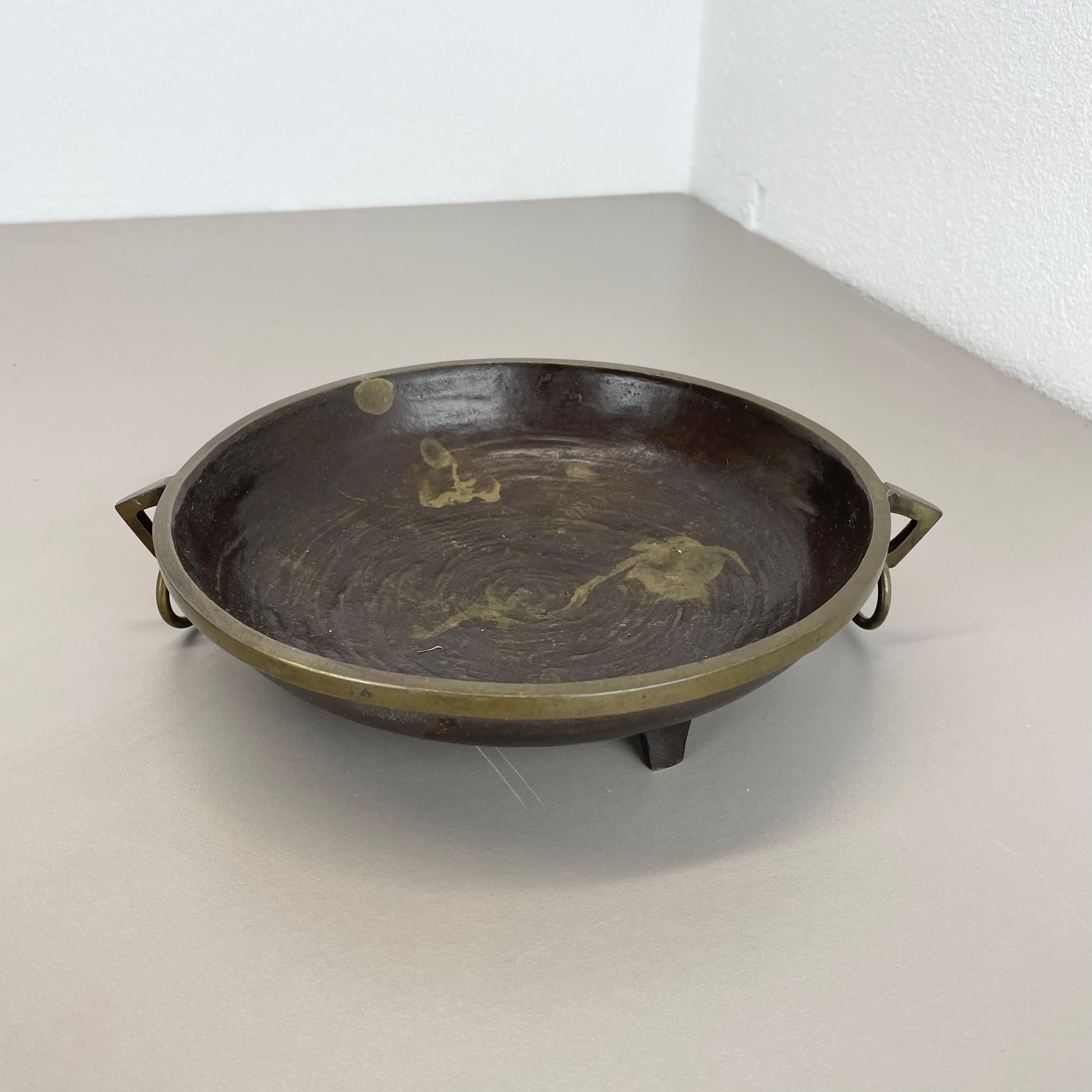 Article:

Brutalist candleholder


Origin:

France


Material:

solid bronze


Decade:

1960s


This original vintage shell plate element, was produced in the 1960s in France. It is made of solid bronze, and has a lovely patination due to the age of