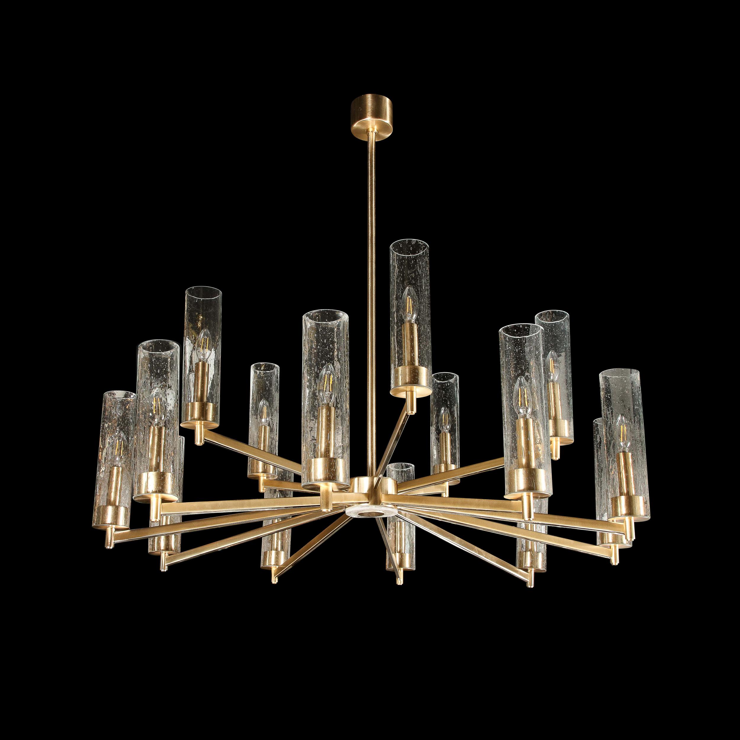 This stunning and graphic modernist chandelier was realized in Italy during the latter half of the 20th century. It features 15 rectilinear arms in brushed brass extending from a volumetric circular body with a brass center surrounded by textural