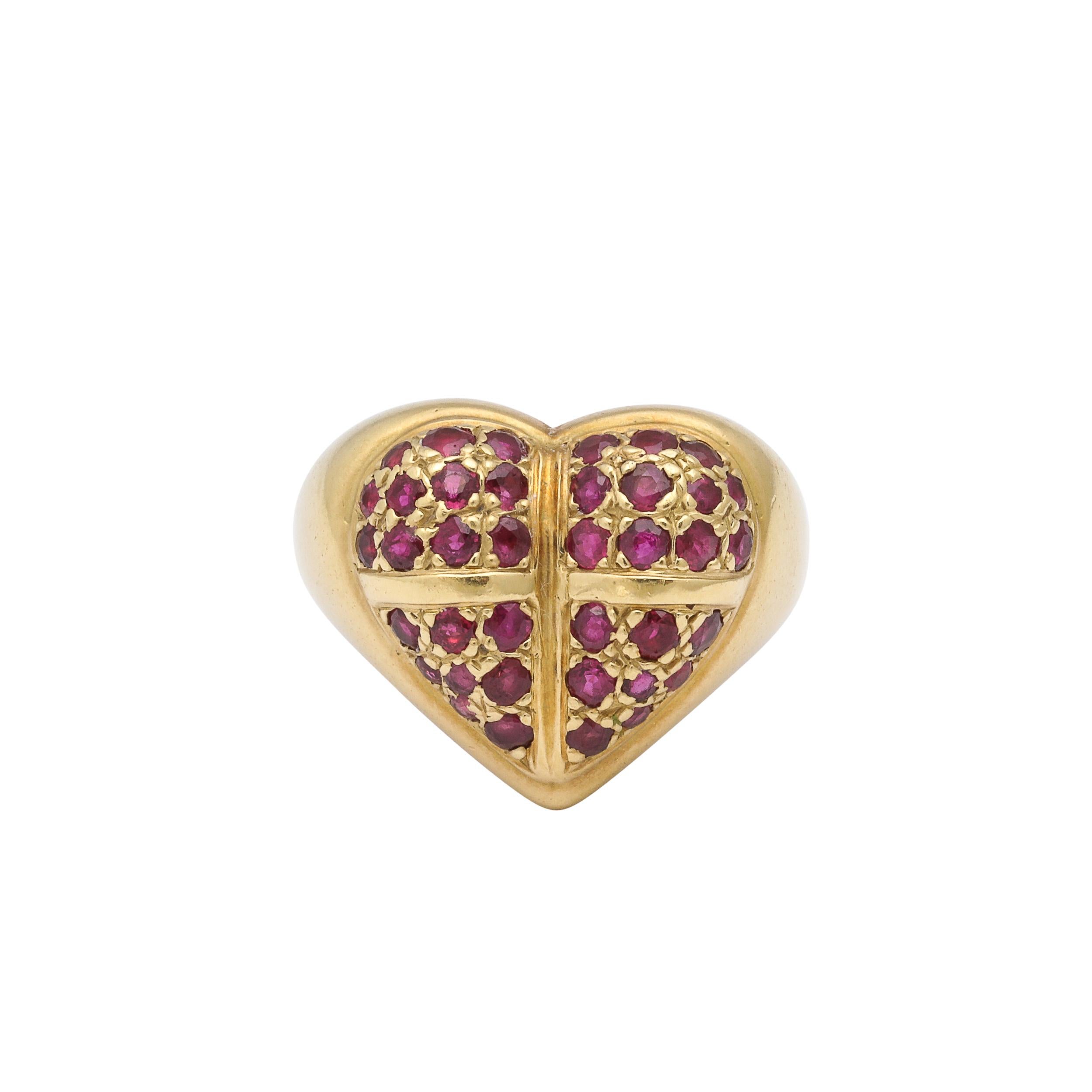 This beautiful Modernist 18 Karat Gold and Ruby  Heart Ring is fabricated and signed Kisselstein Cord and originates from the United States, Circa 1990. Features a beautiful heart shaped profile rendered in 18Karat Gold and encrusted in rubies,