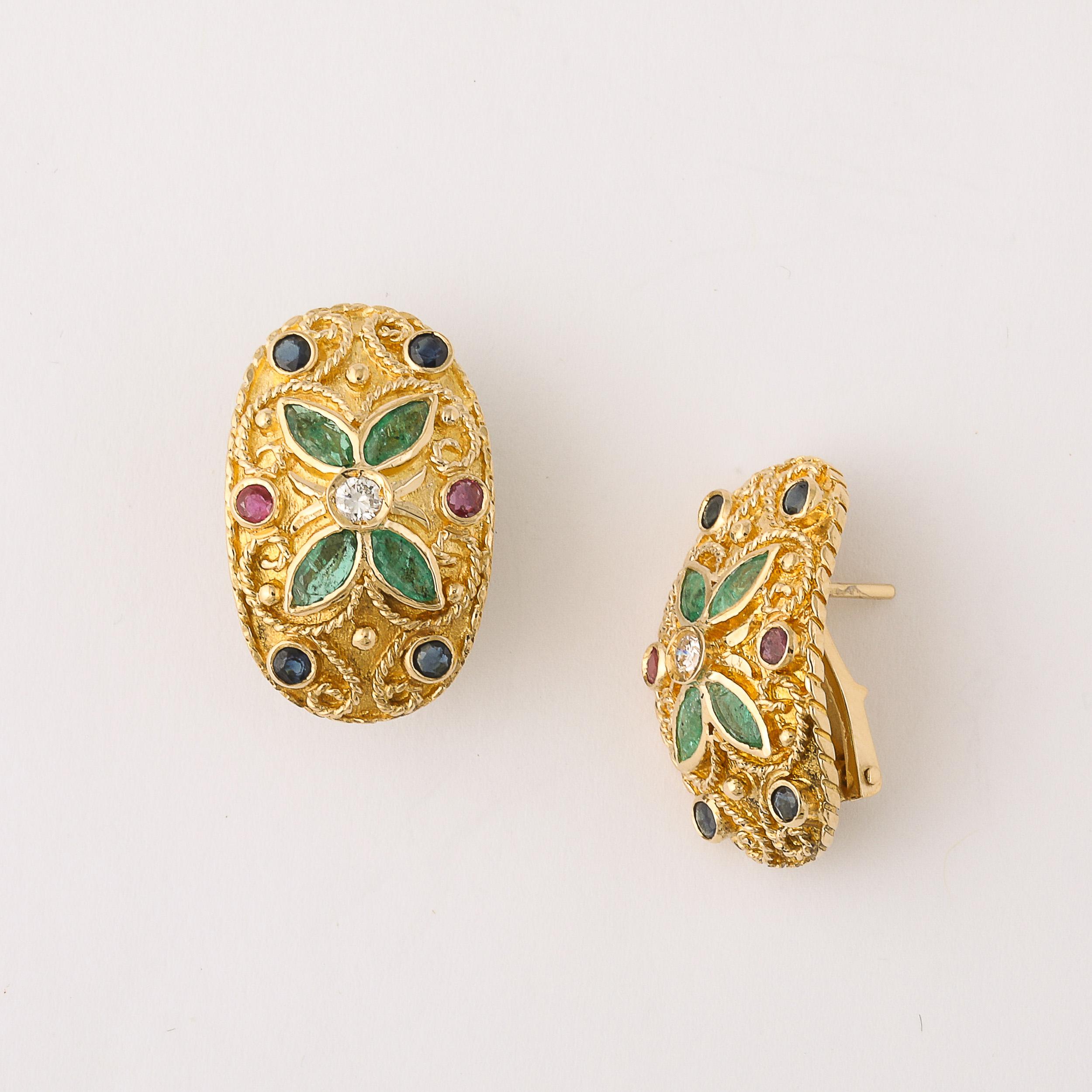 This exquisite pair of Mid-Century Modernist 18-karat gold earrings, adorned with emeralds, diamonds, rubies, and sapphires, originates from Italy and dates back to circa 1950. Crafted with timeless elegance, the earrings feature a shield-shaped