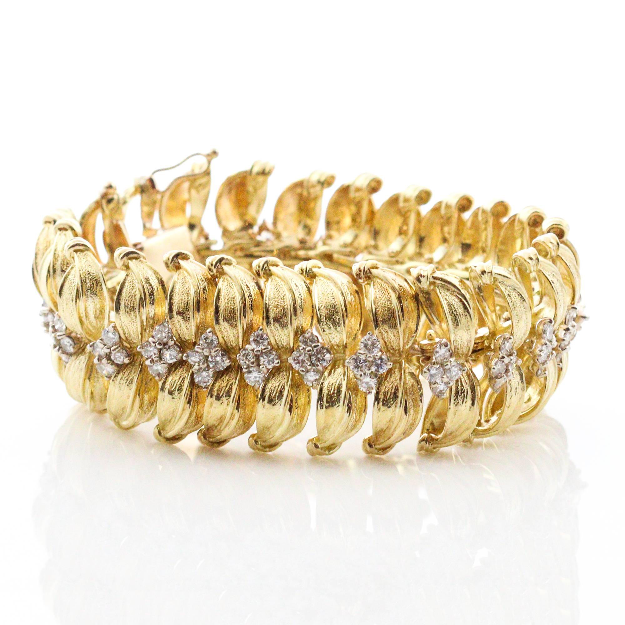 This Modernist bracelet features yellow gold leaf inspired link designs, each one containing 4 round brilliant cut diamonds. There are a total of 100 round diamonds, which weigh a combined total of approximately 7.00ctw and grade as 