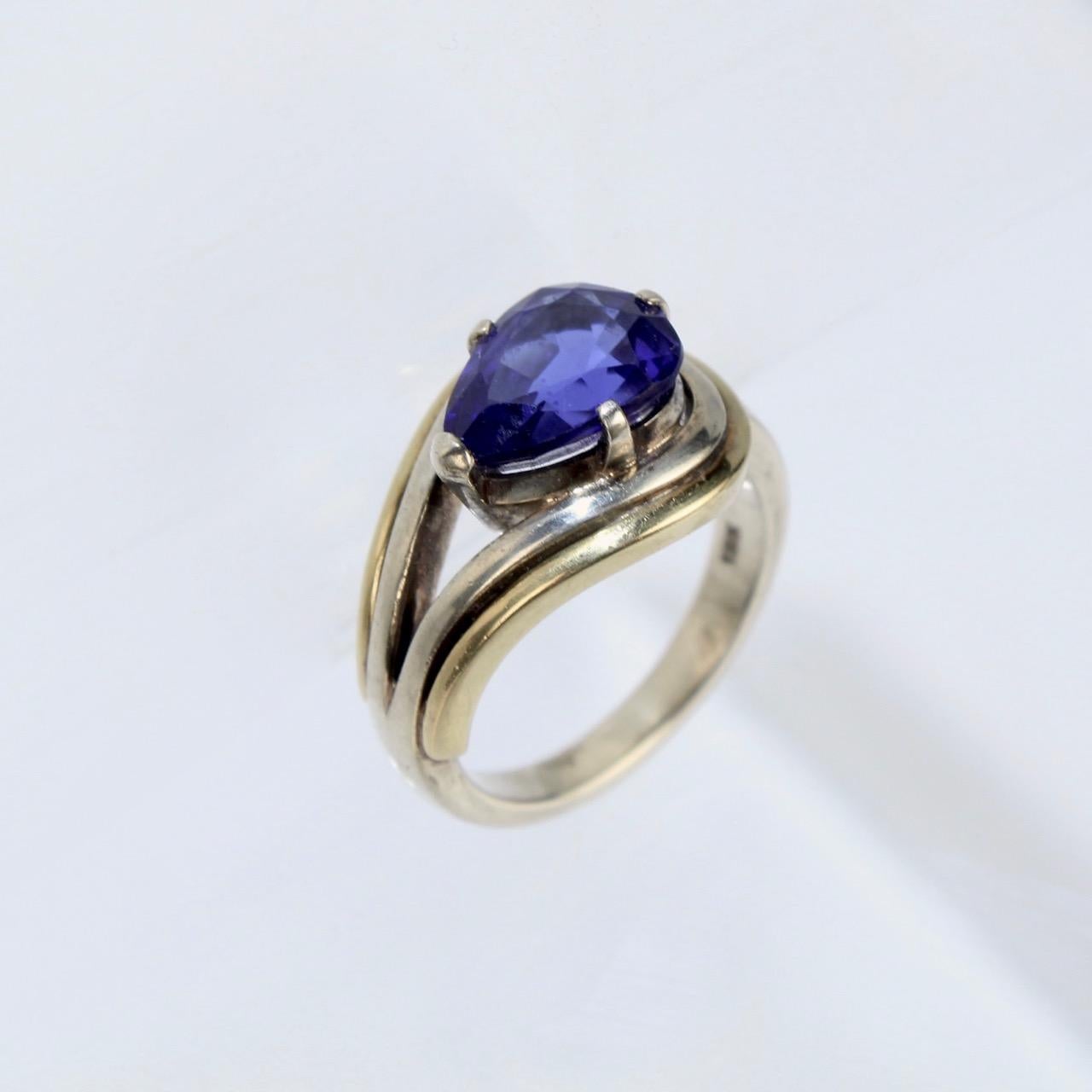 A fine modernist cocktail ring. 

In sterling silver with 18k gold elements.

Set with a pear cut dark blue tourmaline gemstone.

Simply wonderful design!

Date:
20th Century

Overall Condition:
It is in overall good, as-pictured, used estate