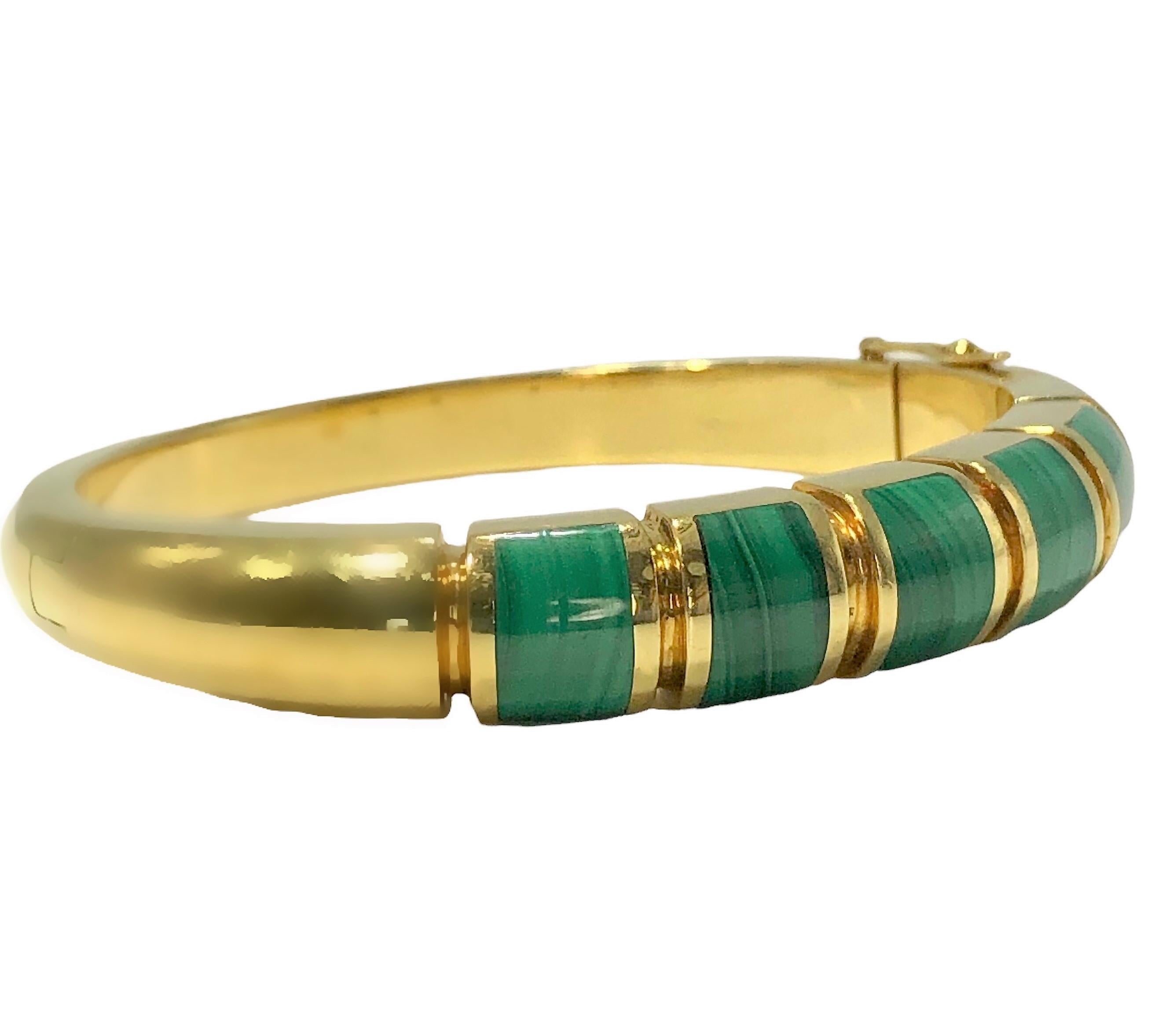 This very well constructed 18K Yellow gold and malachite modernist bangle bracelet was made by the Spanish designer, S'Paliu. At the front are five separate stations, each inlaid artfully with bombe malachite slabs. Measures just over 3/8 inch at