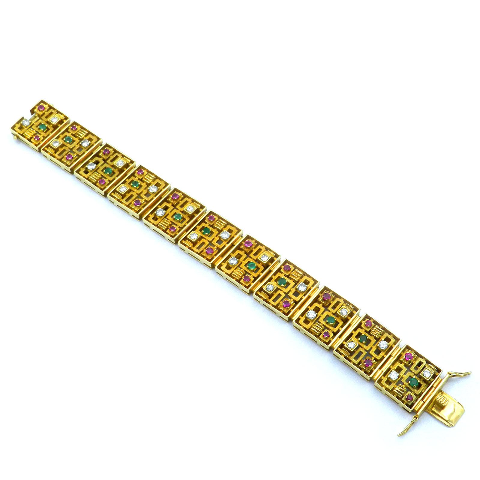 Modernist 1.9 Carat Diamond Ruby and Emerald 18K Gold Bracelet Meran 1970

Decorative gold bracelet with multi colored gemstones in intrecate workmanship, the rectangular links with a structured surface, geometrically openwork and set with rubies,