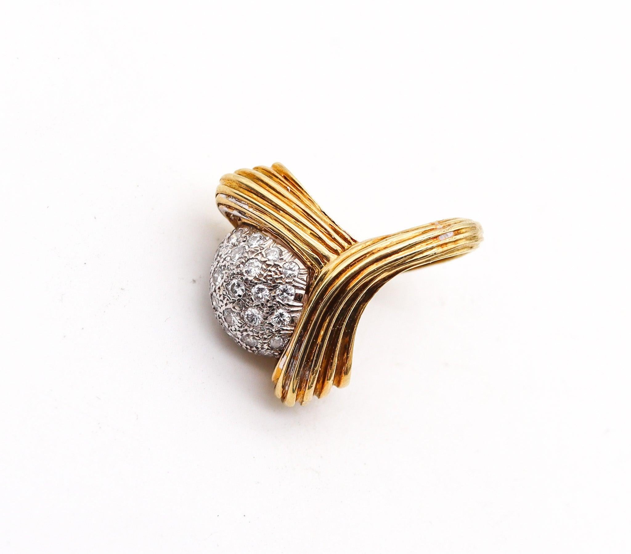 Retro modernist cocktail ring with diamonds.

This is a very interesting cocktail ring, created in Italy during the modernist period, back in the 1970. The ring has been crafted with an unusual retro shape in solid yellow gold of 18 karats and white