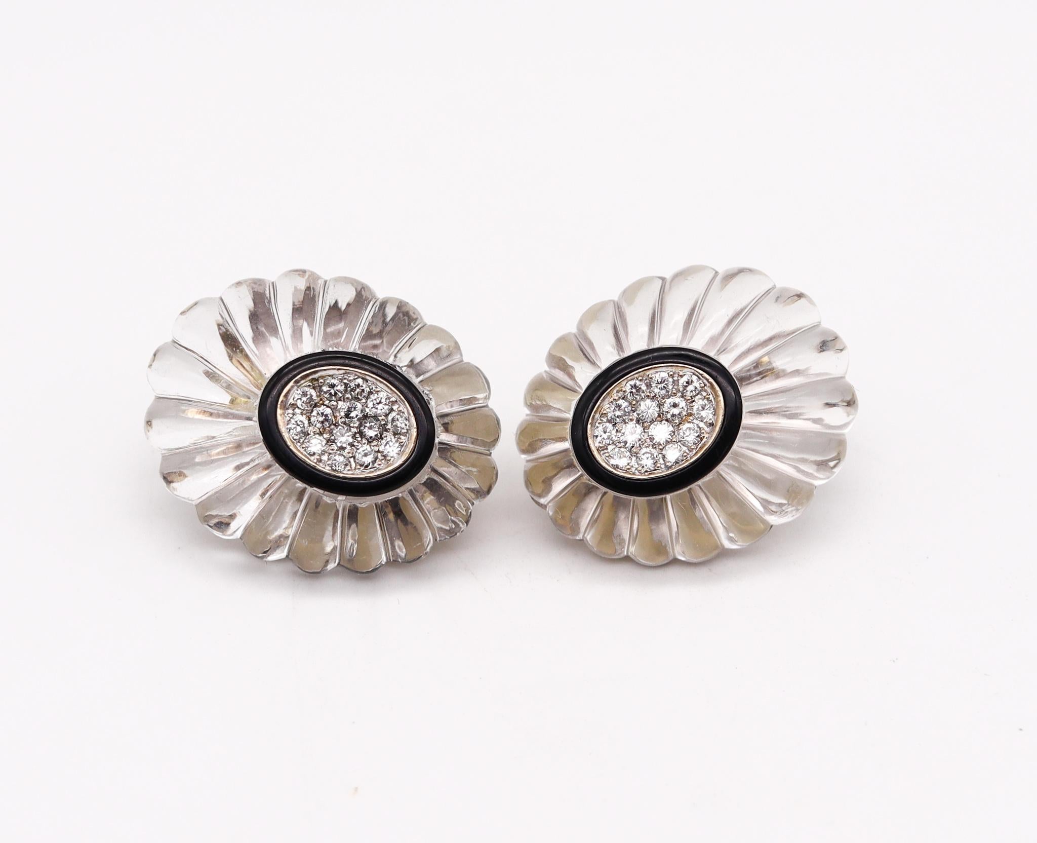 Modernist clip on fluted earrings with gemstones.

Very flamboyant pair of earrings, created in America during the modernist period, back in the 1970. These oval clips earrings are very unusual and handsome, they was crafted in solid white gold of