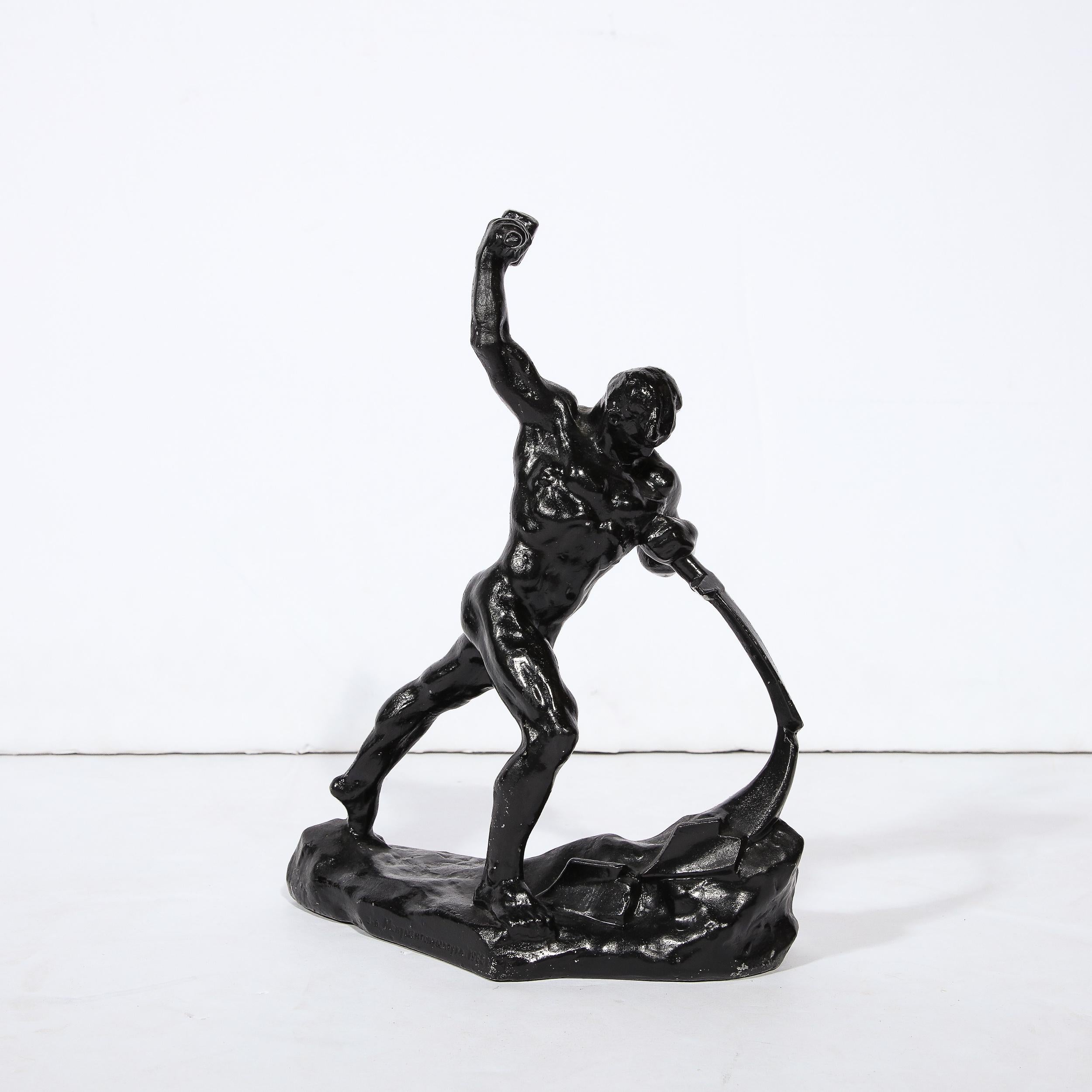 This handsome sculpture was realized in Russia in the 20th century. Created in blackened bronze, it features a male nude figure in the process of forging a sword. He is portrayed mid swing as he strikes the sword with a Hammer. His body torqued all