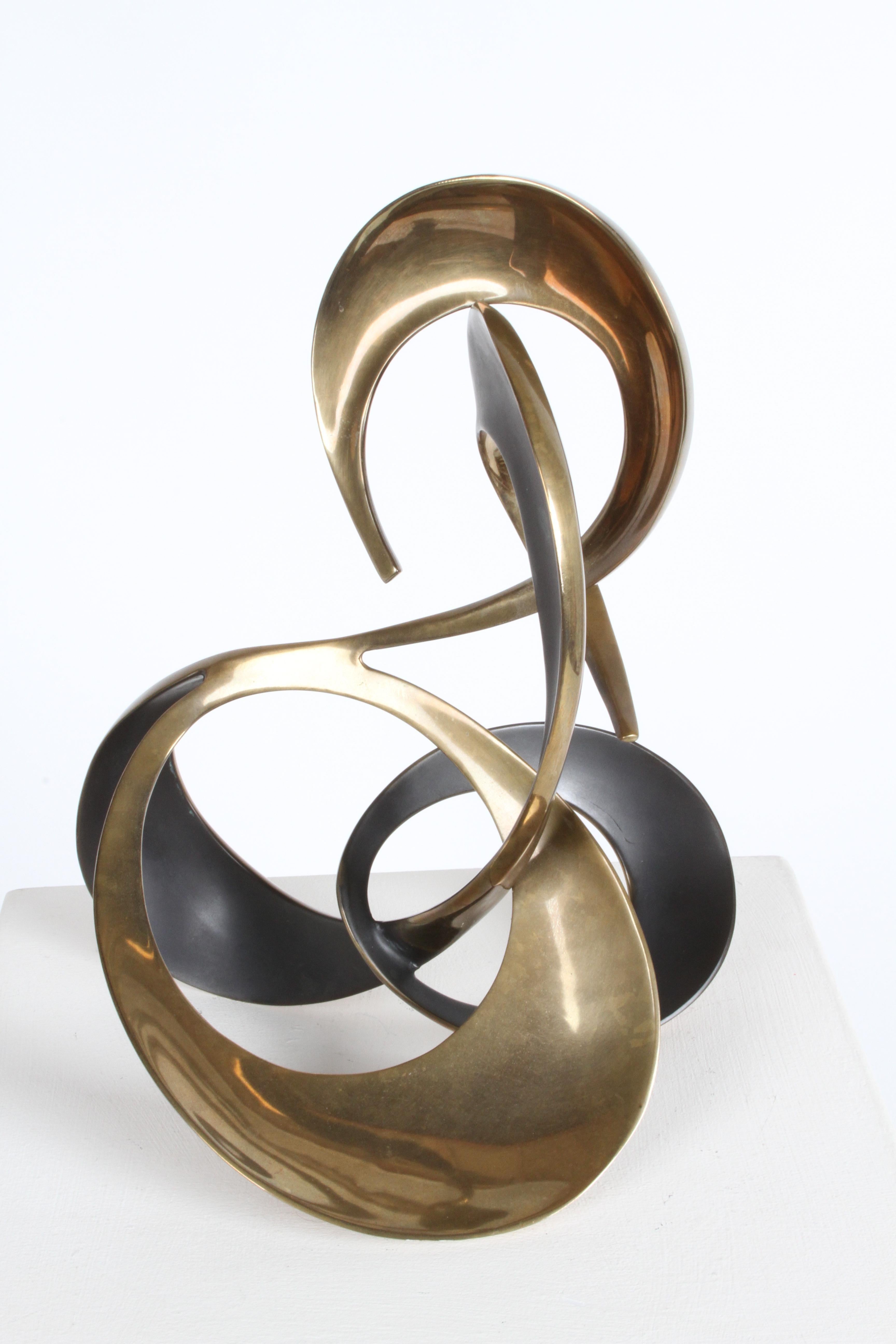 1980s bronze abstract sculpture by California artist Bob Bennett (1939-2003). This is number 80/100 and is signed and dated 1989. Some of the sculptures ribbon forms, have been oxidized for a contrast by the artist. 
Over all in fine condition.