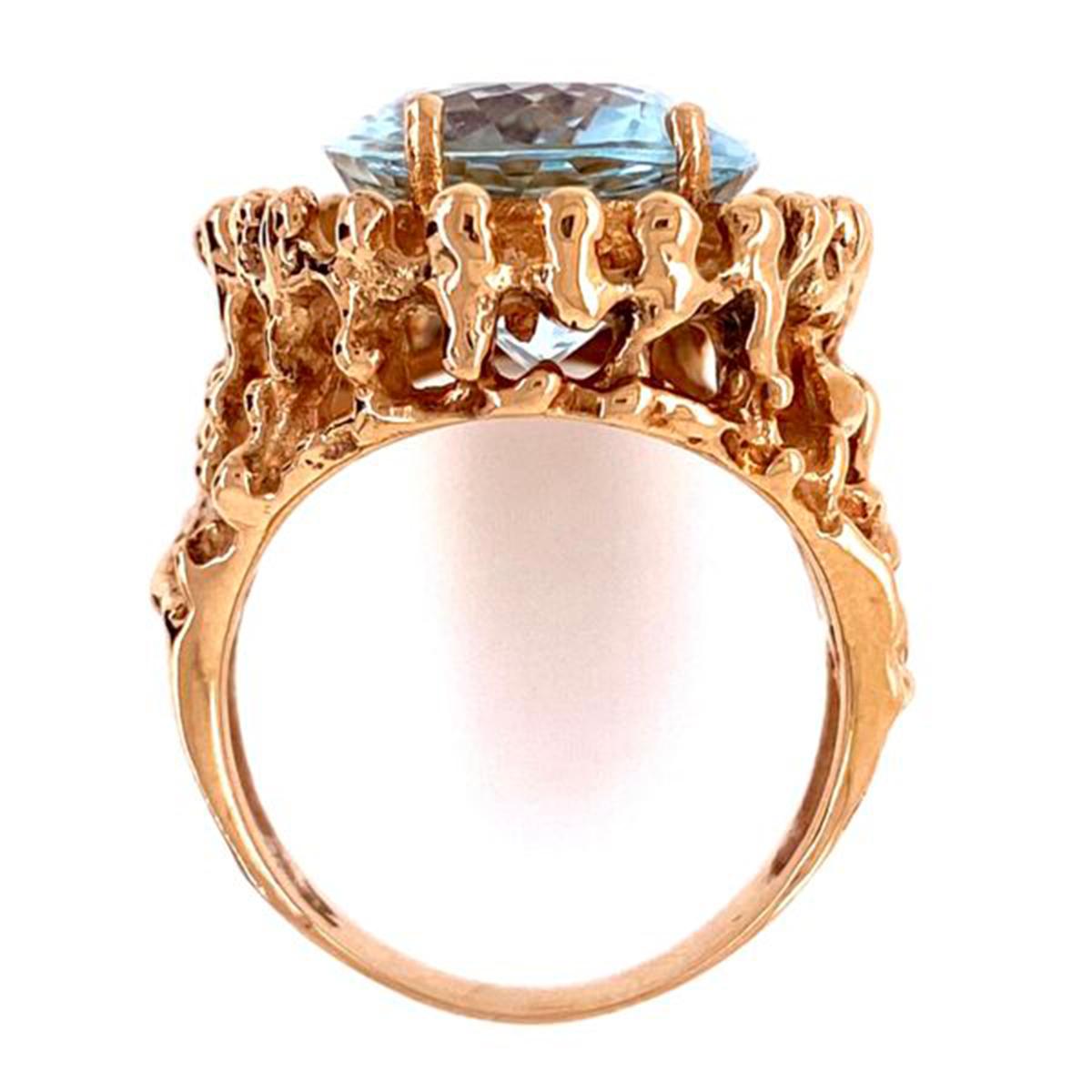 Simply Beautiful, Elegant and finely detailed Mid Century Modern Cocktail Ring; center set with an oval Aquamarine Sapphire, weighing approx. 8.92 Carats. Hand crafted and Hand Textured surround in 14 Karat Yellow Gold. The ring epitomizes vintage