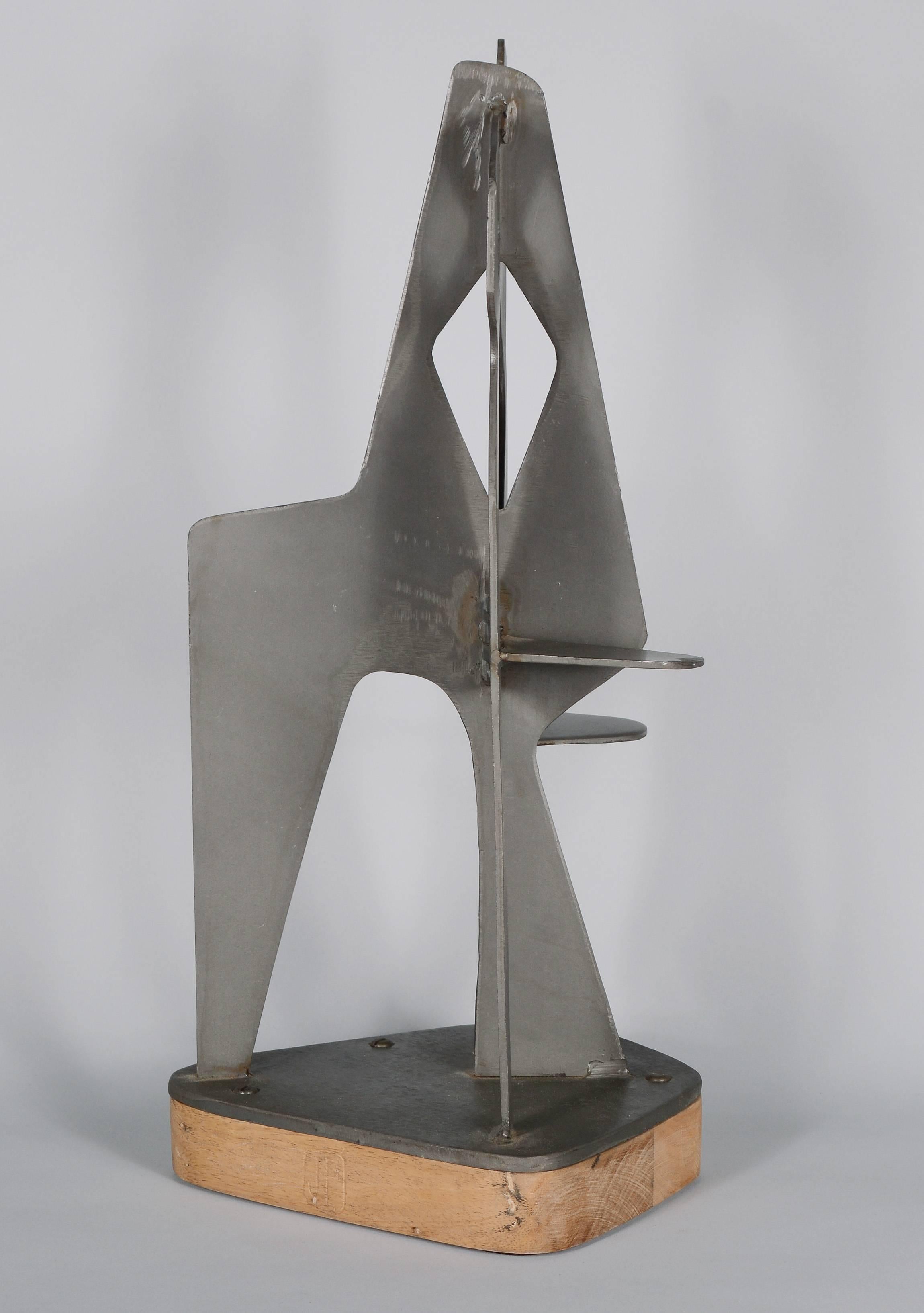 Modernist steel sculpture with an Alexander Calder influence.  Intersecting cut out steel planes create a variety of different shapes when viewed from various angles. An anonymous piece only signed with a JP monogram. 