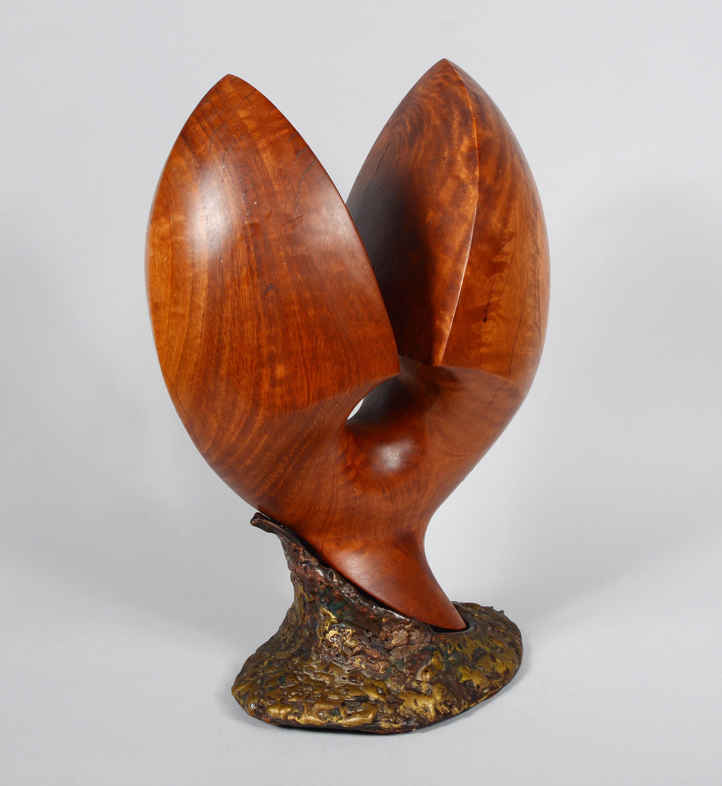 Carved wood sculpture with a Brutalist metal base. This is one of a group of sculptures we acquired by an anonymous artist. This dates to the 1950s-1960s. The sculpture is not signed.