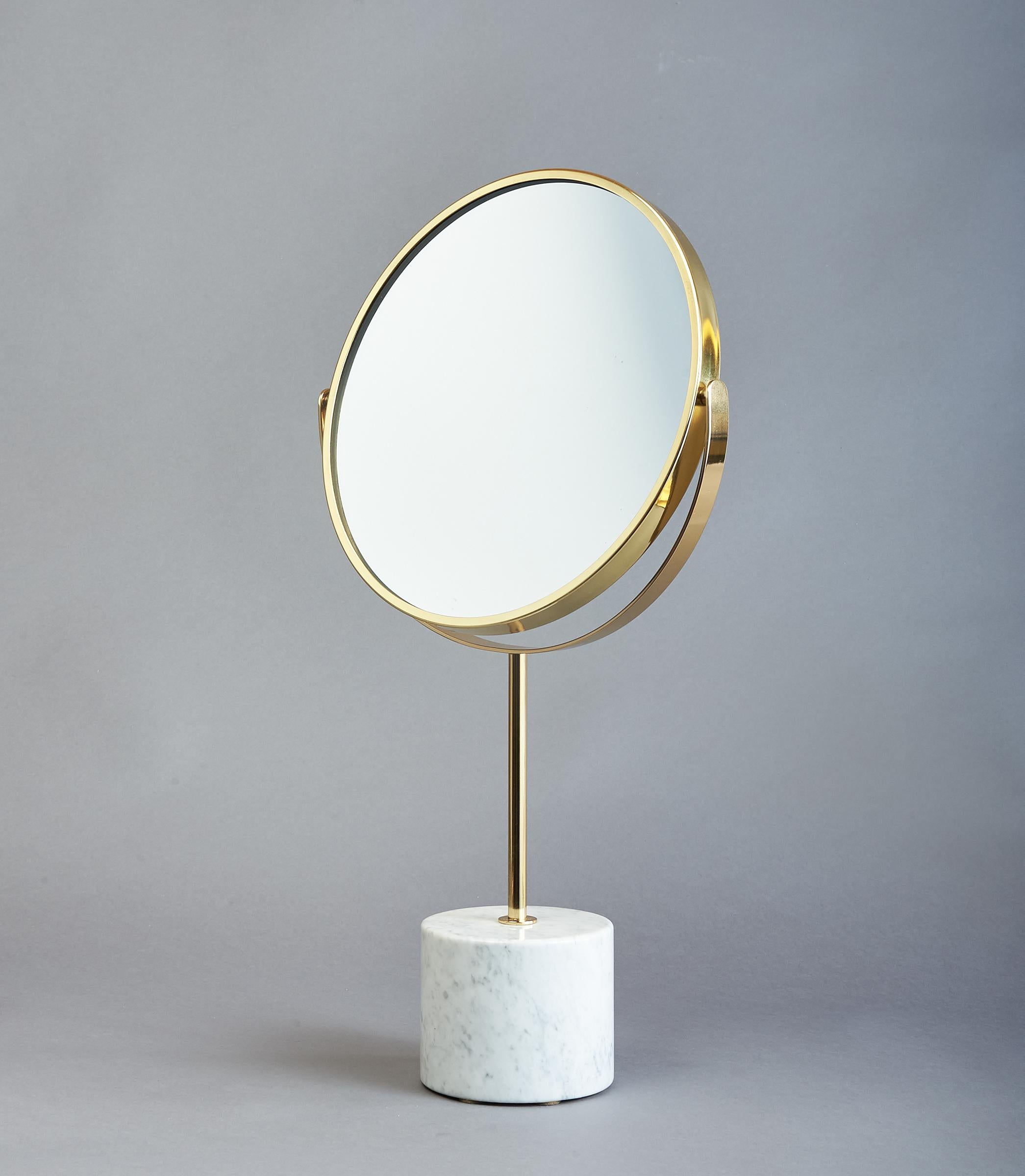 Elegantly proportioned modernist adjustable table mirror with polished brass frame and mounts, cylindrical marble base in the manner of Gio Ponti
Italy, 1950's
Dimensions: 23 High x 12.5 Diameter.
 