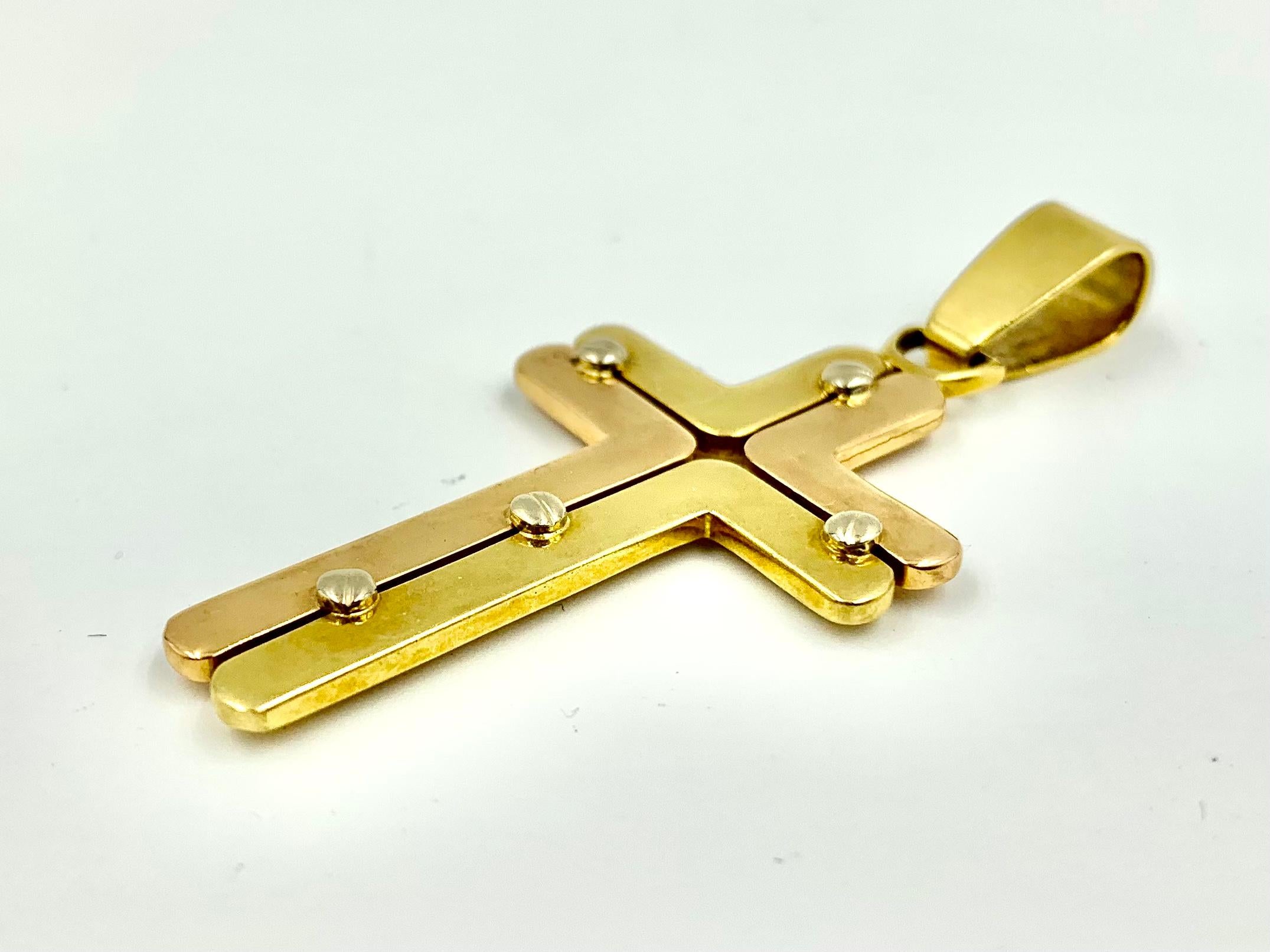 Fine Italian Modernist tri color 18K gold cross by Adriano Chimento.
Bold, unusual design of L shaped substantial panels of yellow and rose gold joined by five white gold stylized screws. The industrial motif of this piece references Jesus'