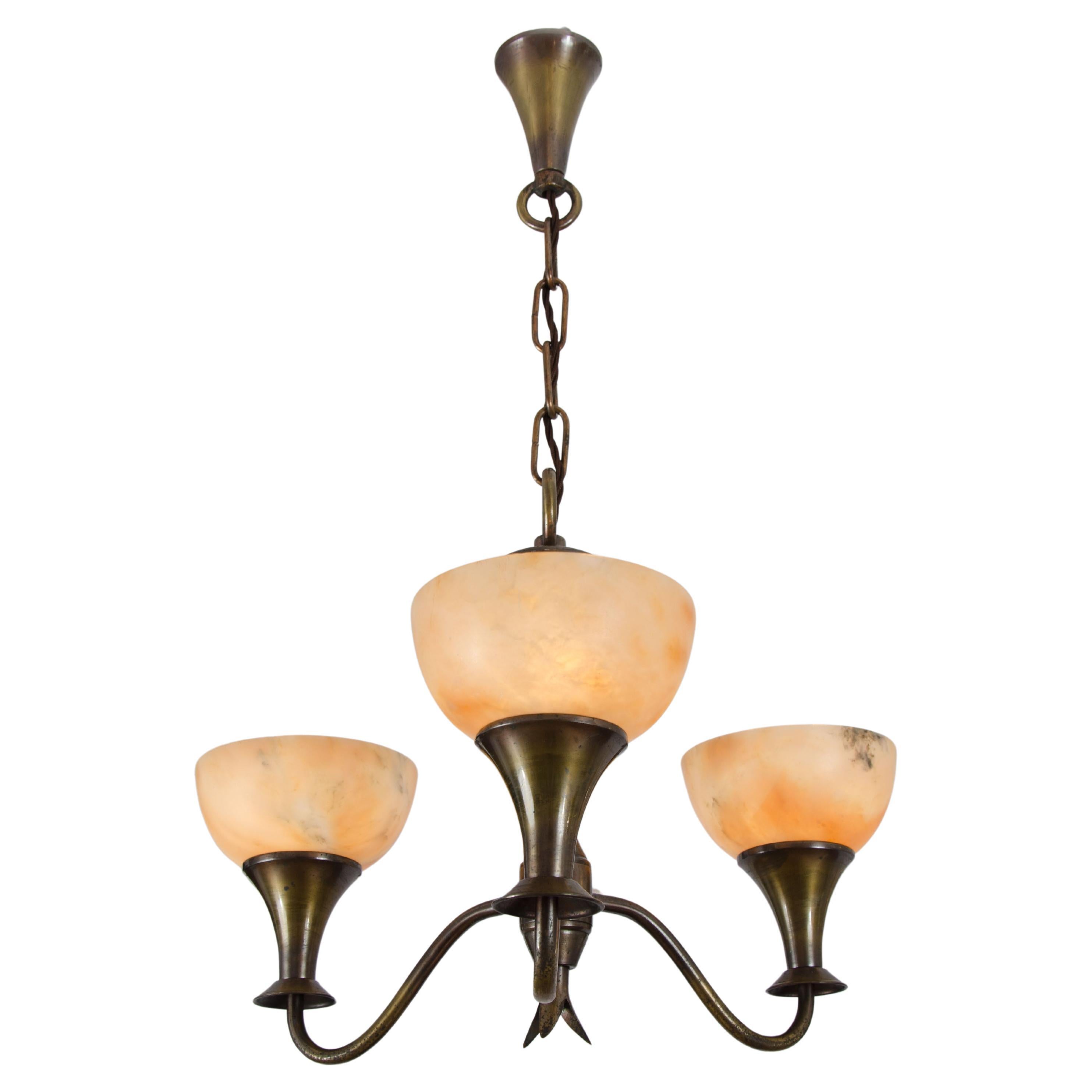 Modernist Art Deco  three arm chandelier with alabaster up lighter shades. Brass metal frame is patinated in bronze. Chandelier is classical in form and shape made in the 1930's in France. Ideal for a hall way or small room.