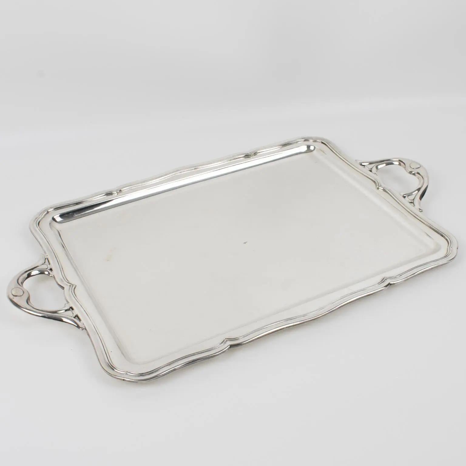 This serving tray is made of Alpaca silver plate and has a modern rectangular shape with raised edges and decorative handles. The underside bears legal silversmith hallmarks and reads 