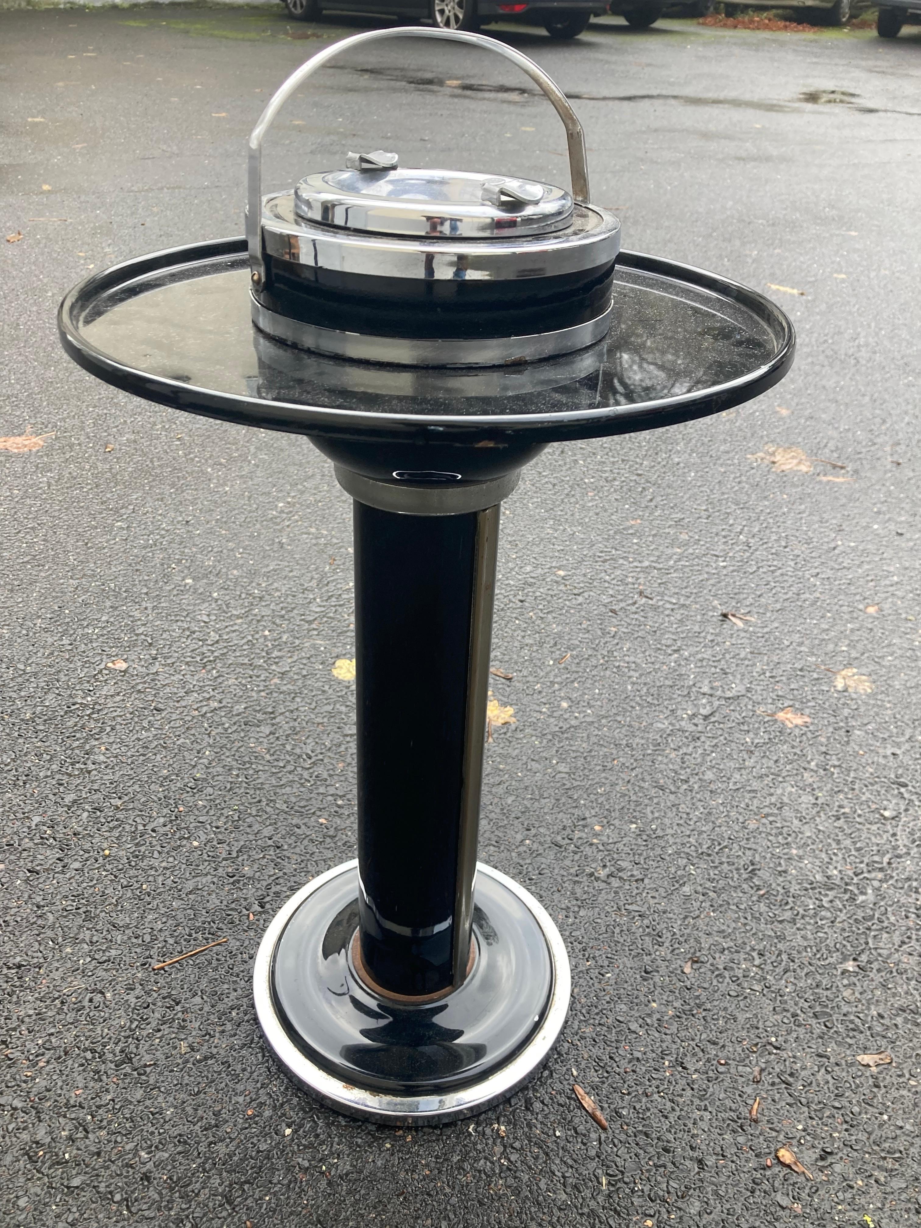 Very rare Modernist American Art Déco smoking table/ standing ashtray in the style of Walter von Nessen. The chase.
Machine Age. 1930s.
Chrome plated steel. Black lacquer finish.
Spherical retractable axle cup in black lacquered metal.
The folding