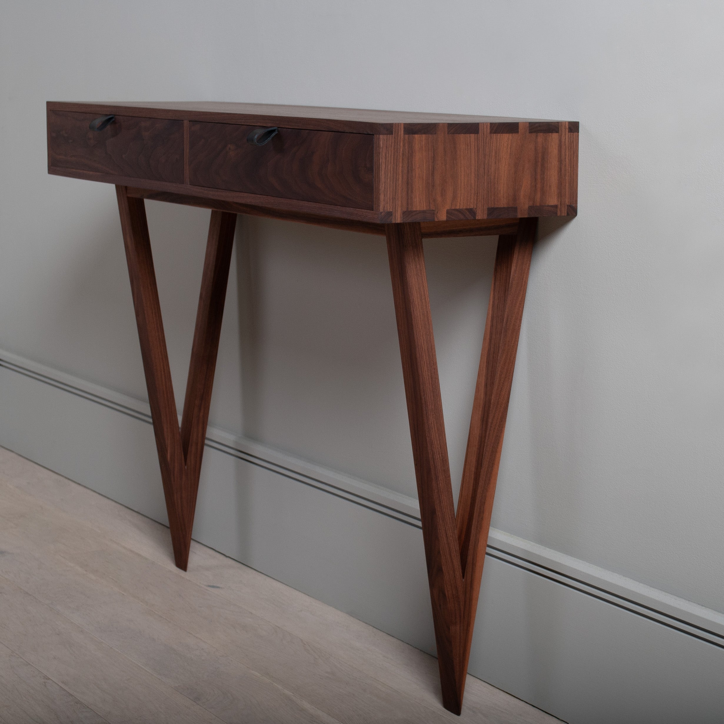 Modernist American black walnut vanity table designed and produced in England using traditional furniture making techniques. Completely handcrafted from the finest American black walnut. Hand dovetailed joints to the main console drawer box and all