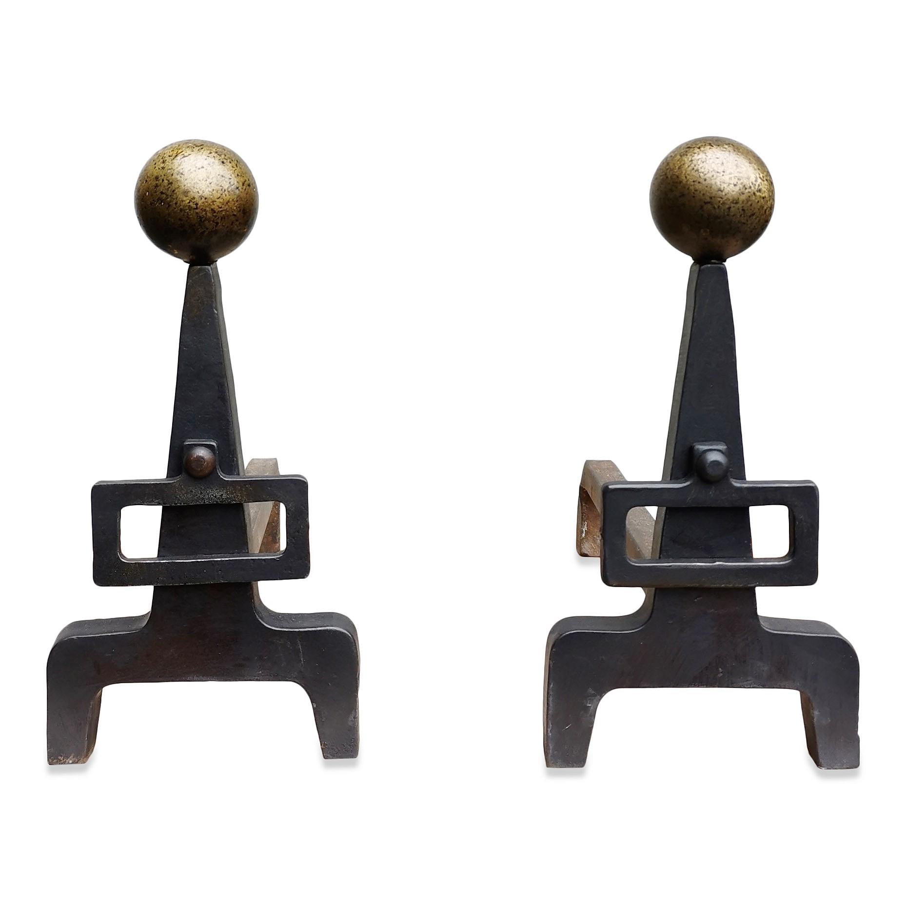 Modernist wrought iron andirons with buckle
Hammered brass balls on top of each andiron.