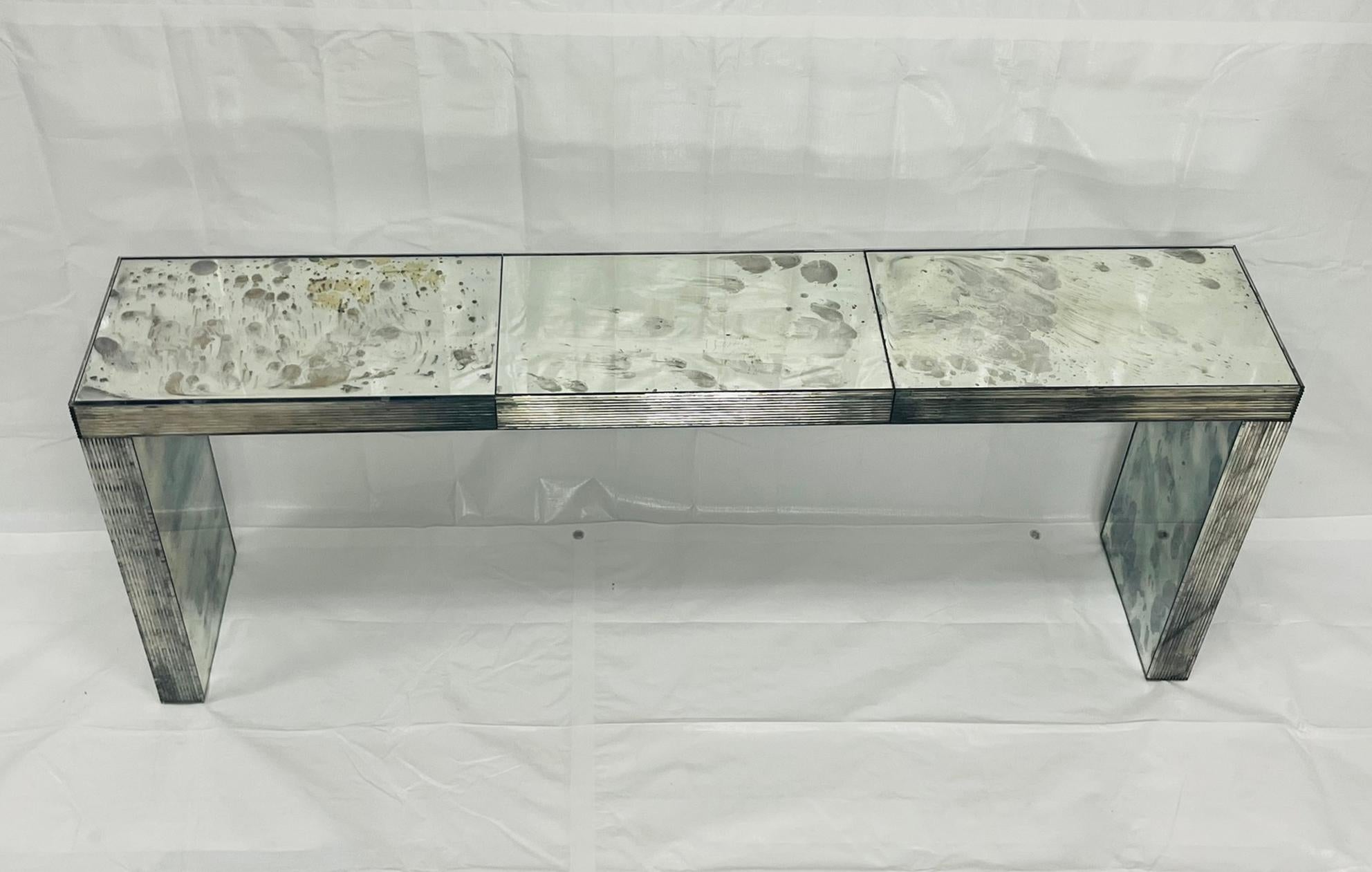 A striking modernist console table designed and manufactured by John Himmel in Montreal, Canada, this piece exemplifies refined craftsmanship and architectural clarity.

The console features an inverted “U”-shaped form constructed from antiqued