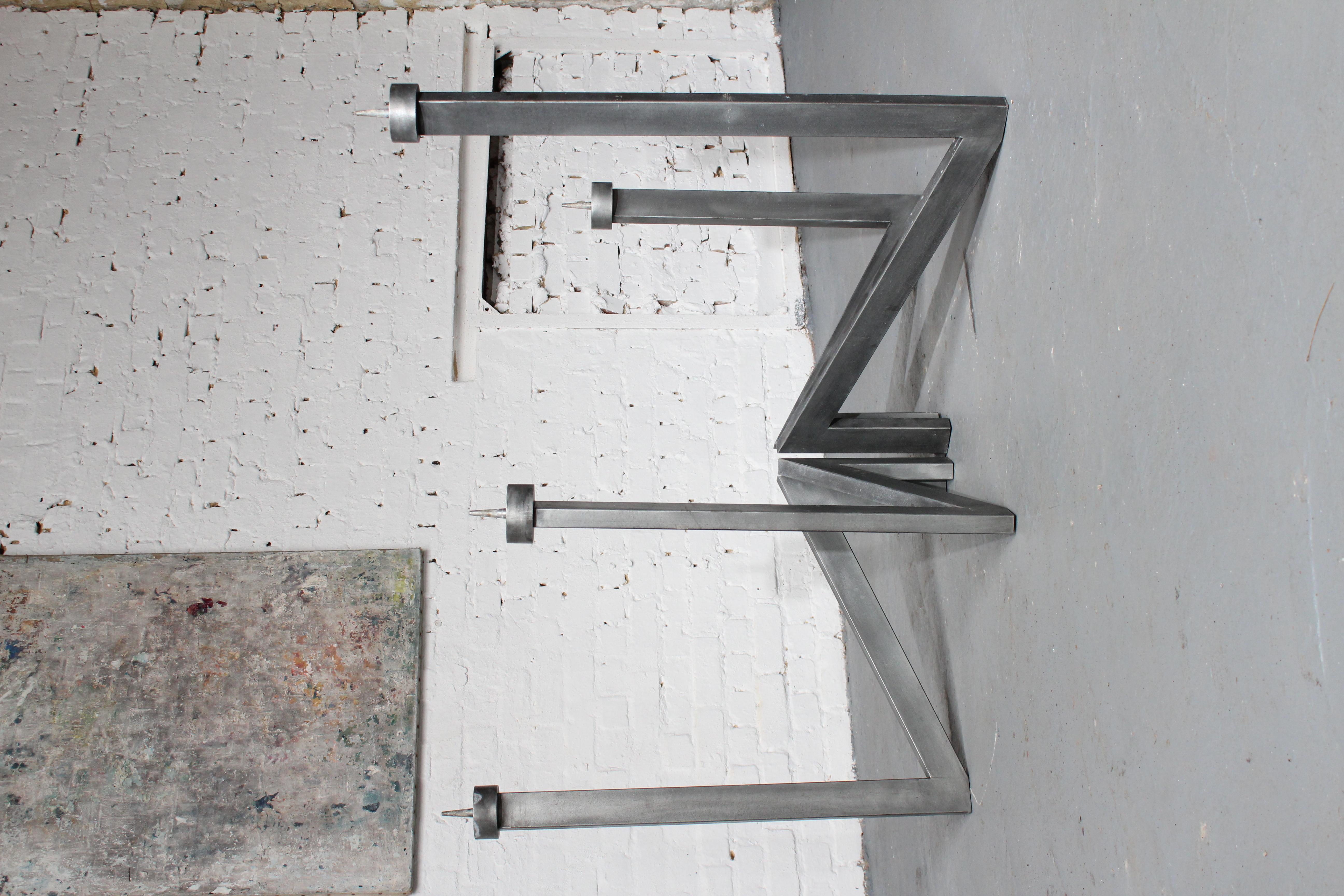 Very large modernist architectural 4-armed candlestick by the Belgian sculptor Roger Bonduel (1930-2019) in welded and patinated steel. This candlestick is modularly constructed from 4 parts with a central attachment point, allowing you to play with