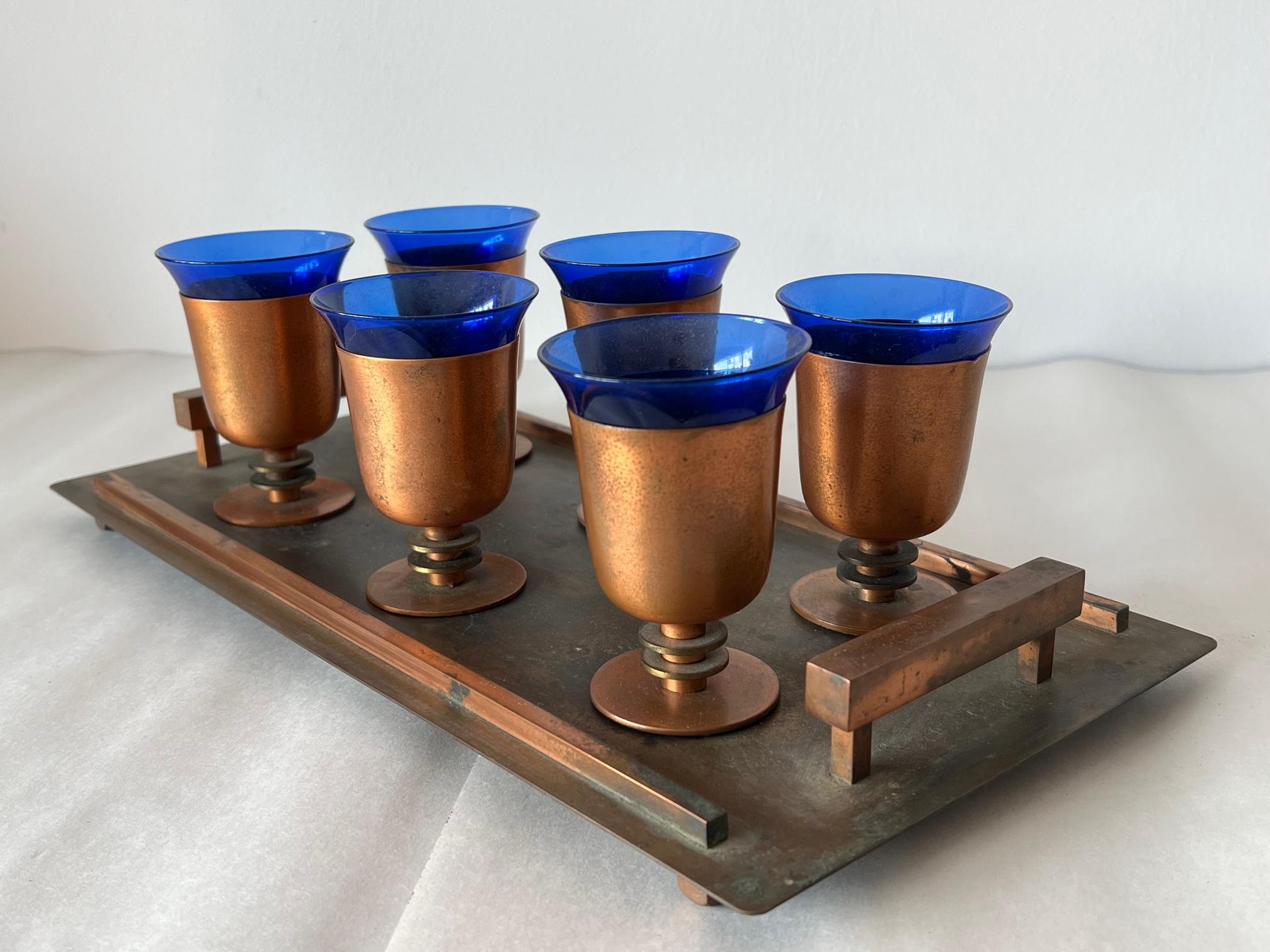 Original Art Deco tray with six matching drinking goblets. An excellent modernist design, heavy-well made, brass and copper, and cobalt glass.