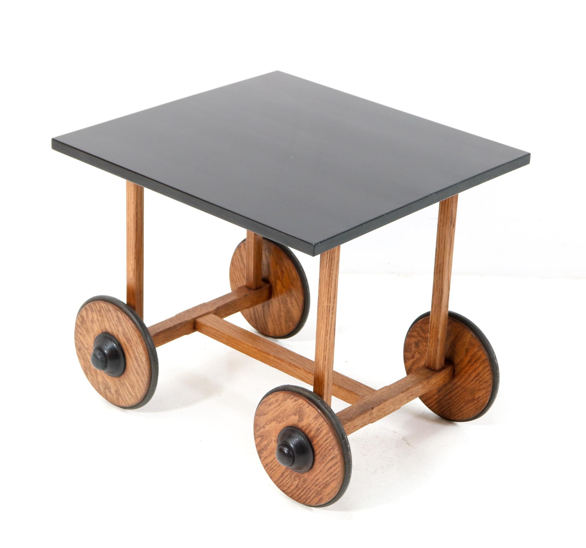 Magnificent and ultra rare Art Deco Modernist serving cart or trolley. Striking Dutch design from the 1930s. Solid oak frame and wheels with original refinished black lacquered beech top. All four wheels are in good working order. This wonderful Art