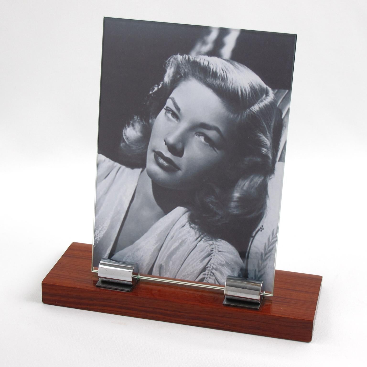 Lovely French Art Deco picture photo frame, featuring thick hand-rubbed high gloss rosewood plinth compliment with two polished chrome metal rounded stick. The frame is complete with its two glass sheets to enclose the photograph.
Measurements: