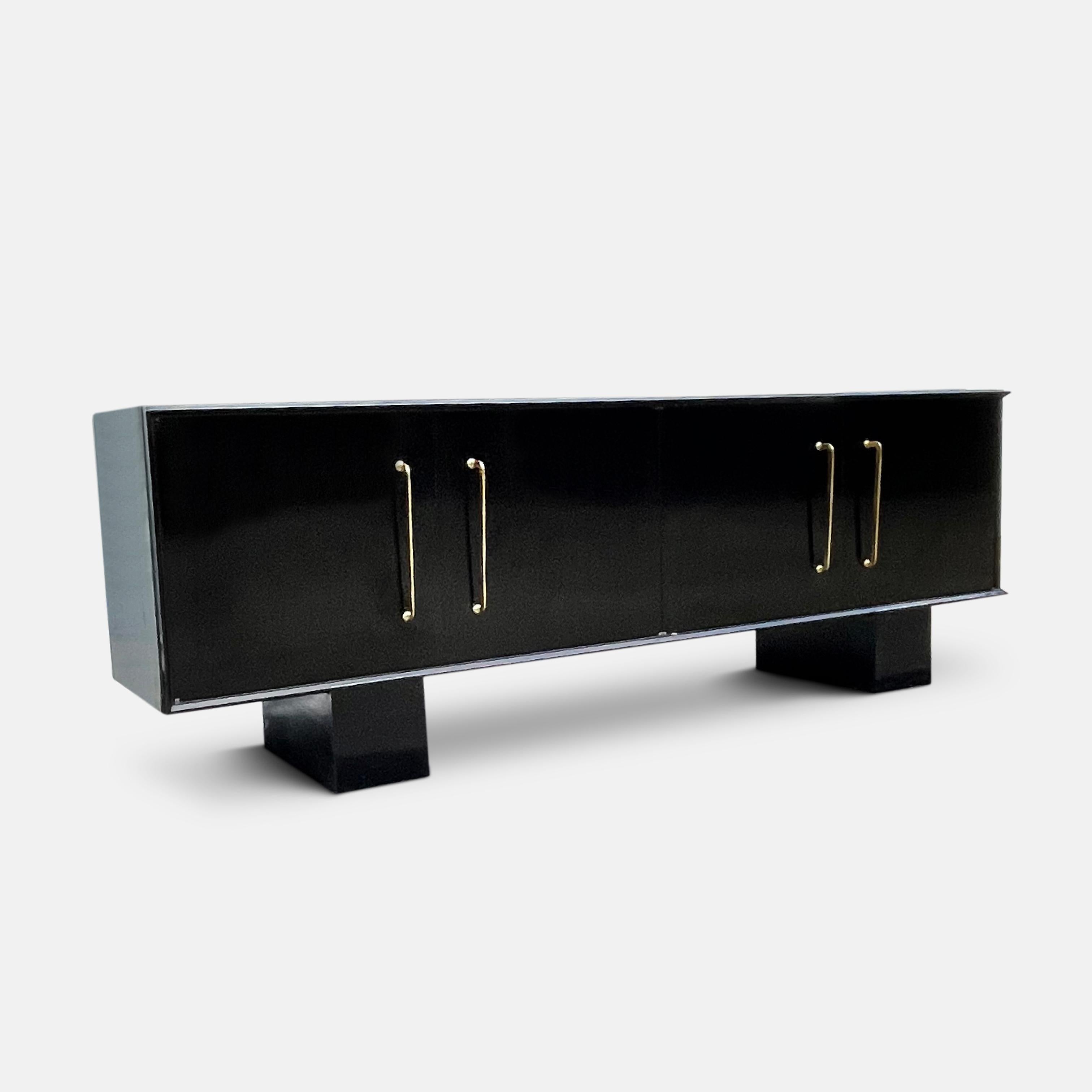 The result of successive eliminations of ornamentation, palette and form, this supremely Modernist sideboard is a masterpiece of the Rationalist approach to design 
The black lacquer stands alone, punctuated by only the gold of the sideboard’s four