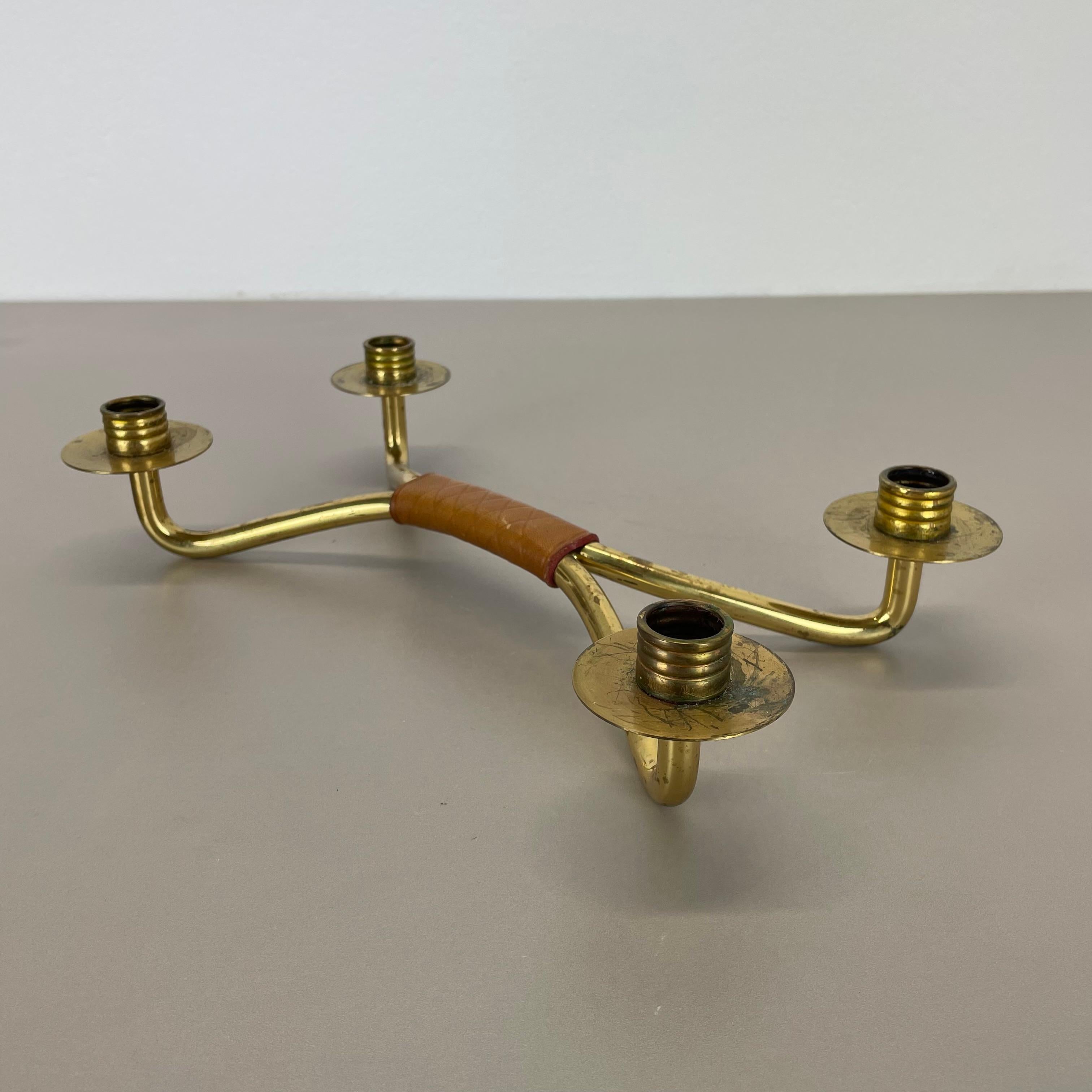 Article:

candleholder element


Origin:

Austria


Material:

brass and leather


Decade:

1950s



This original vintage candleholder, was designed and produced in the 1950s in Austria. It is made of solid brass and a leather handle in the middle,