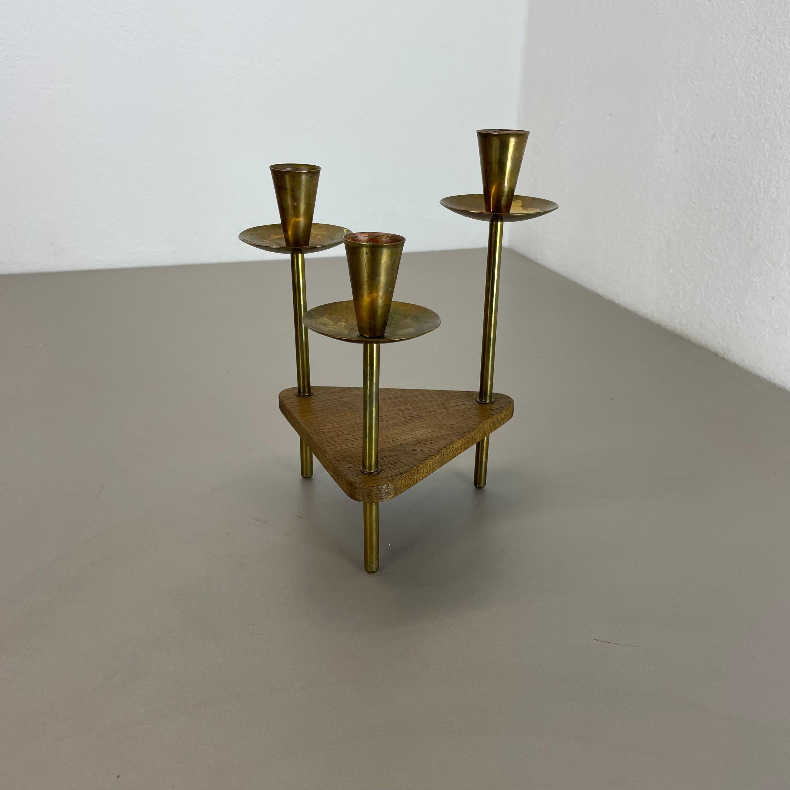 Article:

TRIPOD candleholder


Origin:

Austria


Material:

brass and oak wood


Decade:

1950s



This original vintage candleholder, was designed and produced in the 1950s in Austria. It is made of solid brass and oak wood, and has a lovely