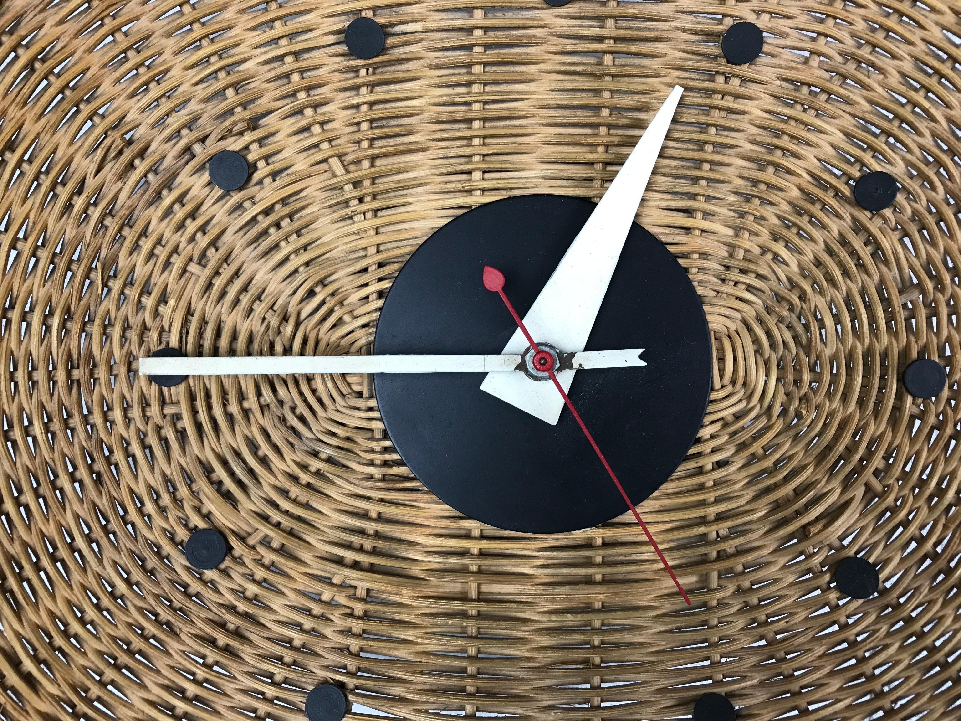 Modernist wicker 'basket' wall clock designed by George Nelson & Irving Harper for Howard Miller. Original condition - the clock does work. Label present.