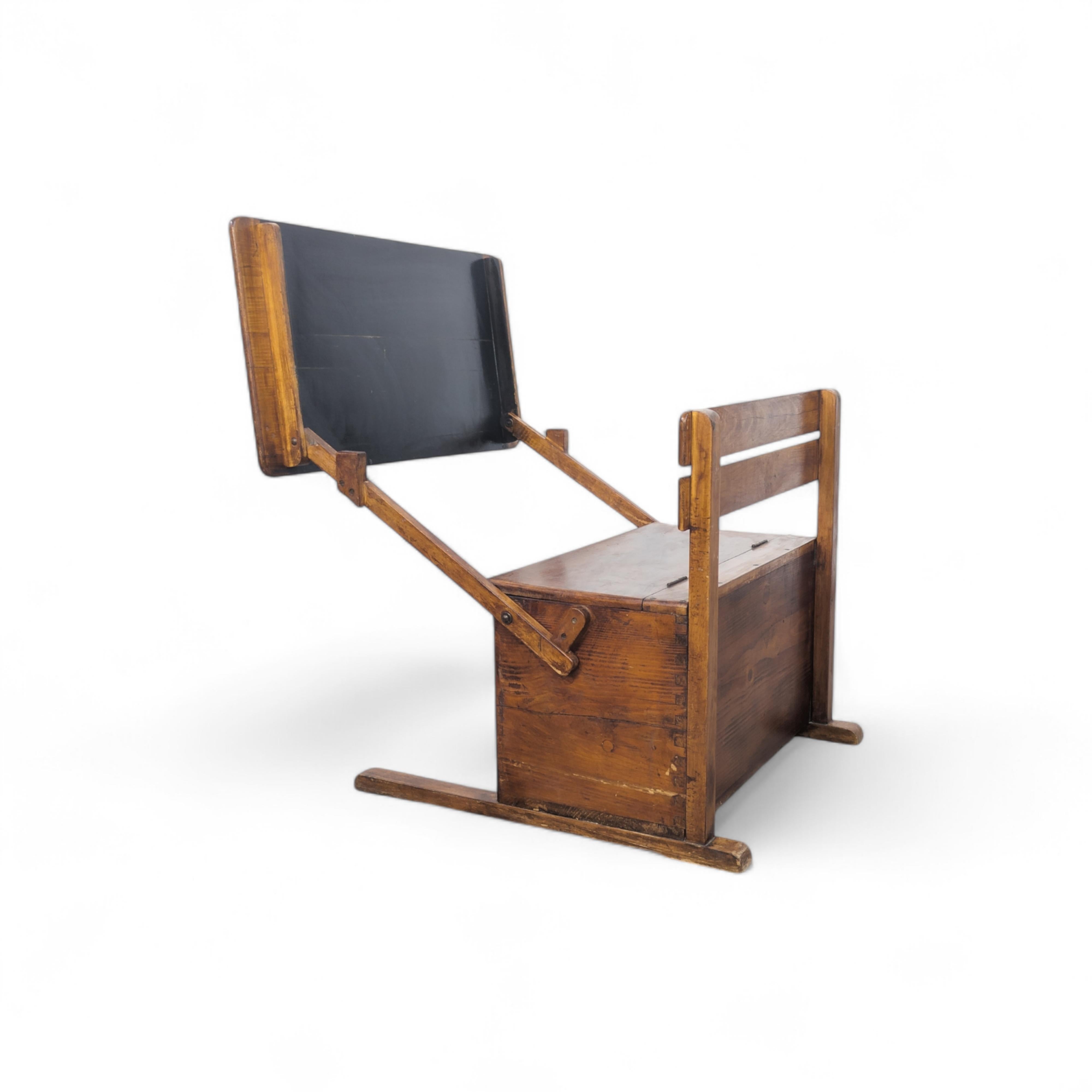 A charming modernist 1920s wooden school desk for young children, featuring a chalkboard and storage space beneath the seat. Designed for kids up to 5 years old, this desk is made of solid wood and was manufactured in former Czechoslovakia. It