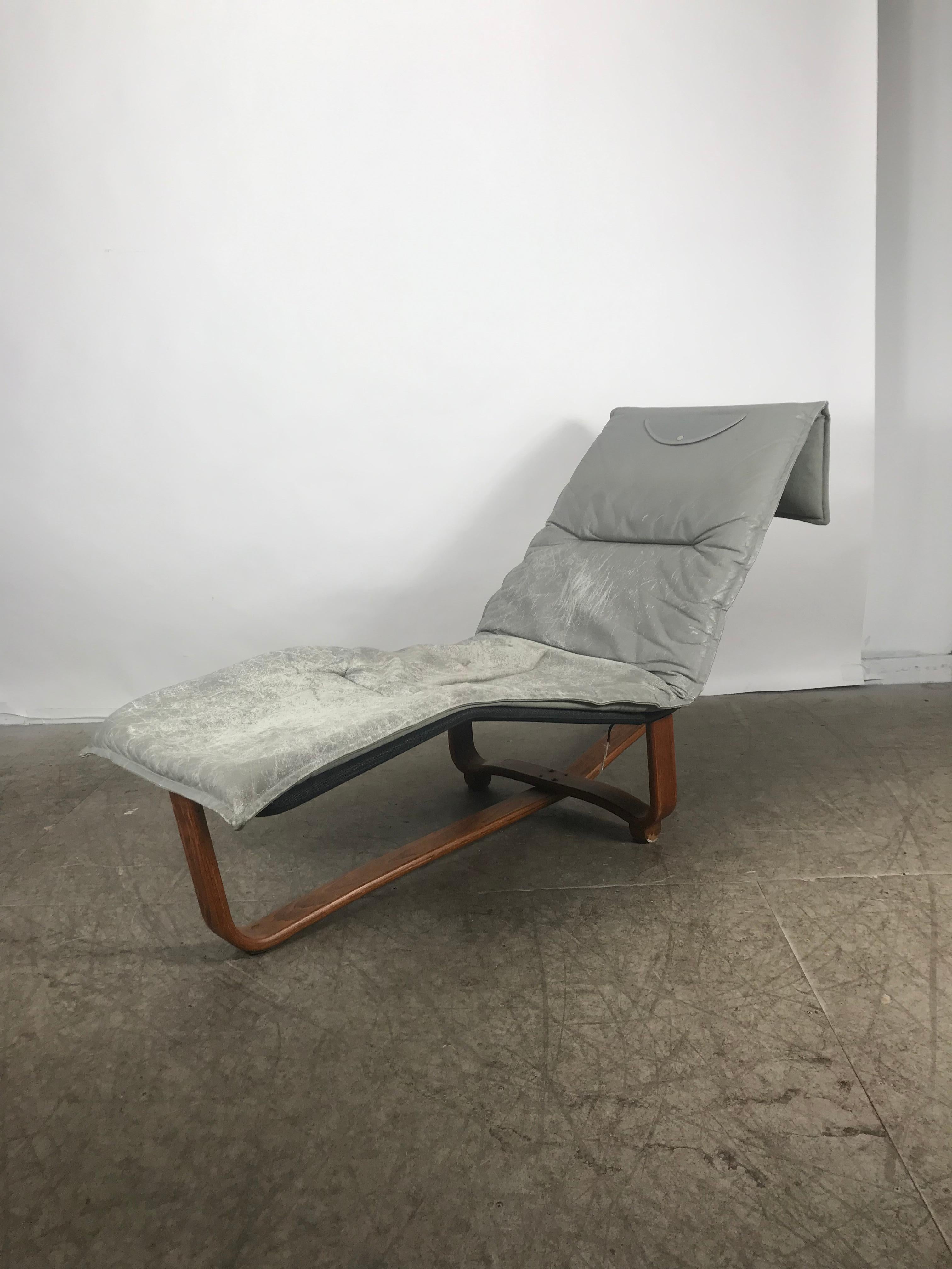 This stunning vintage modern chaise lounge features a stylish and sturdy bentwood base. Versatile design functions as lounge chair to relax on or a daybed for napping. Extremely comfortable piece has a thick padded original leather cushion, hand