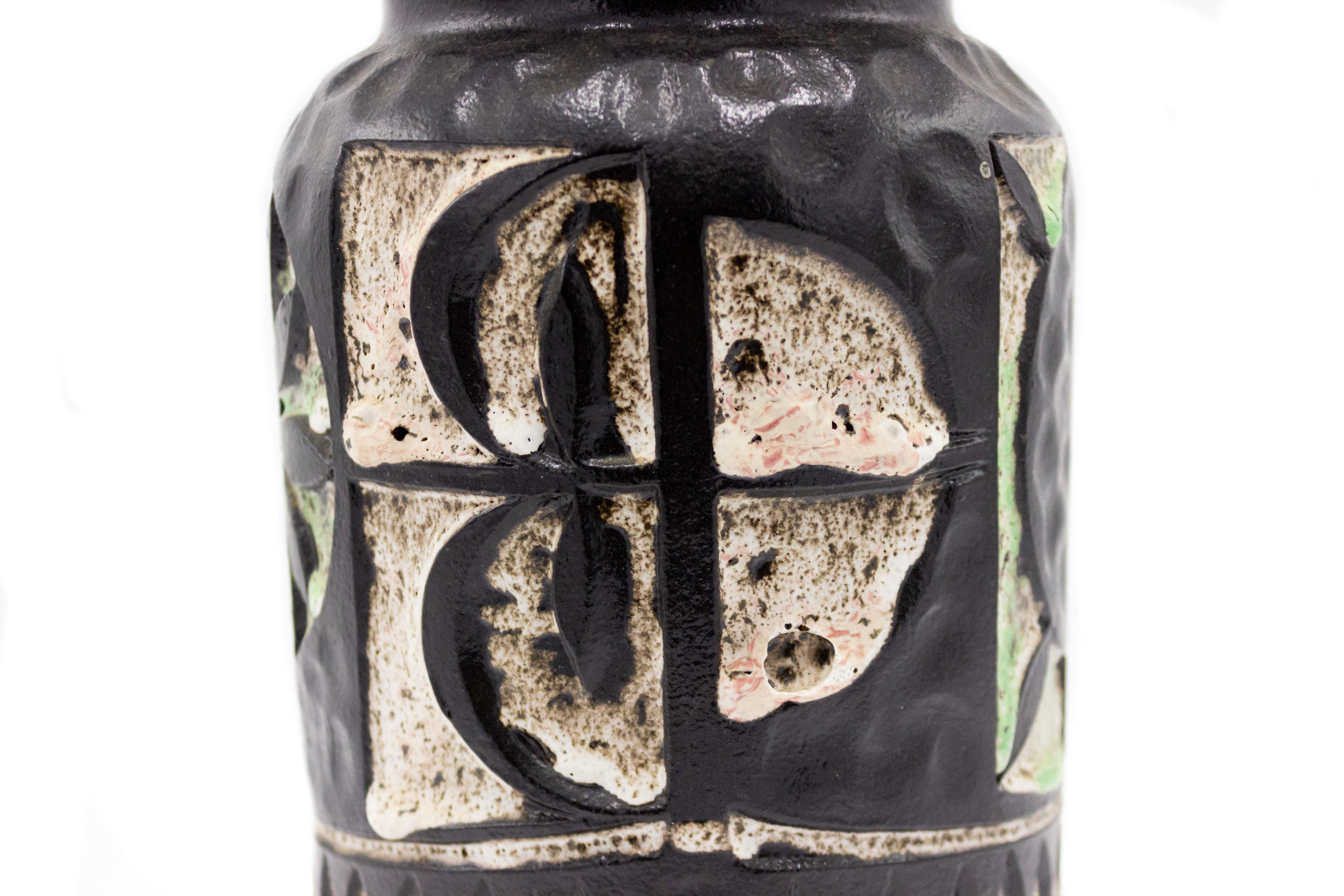 Post War design modernist cylindrical black vase with white and mint green incised floral and geometric patterns.