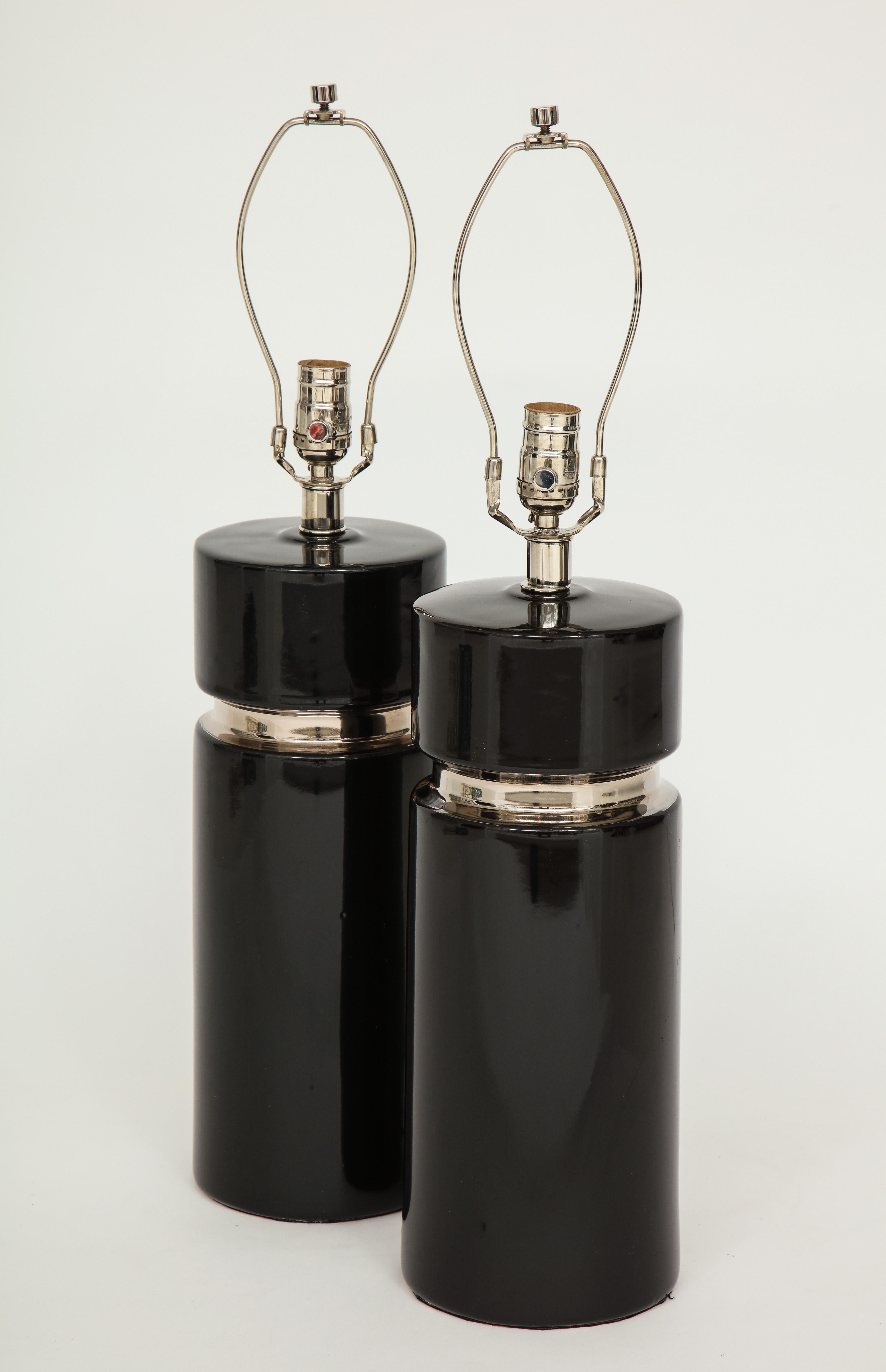 Midcentury black ceramic column form lamps with applied platinum banding. Rewired for use in the USA, 100W max.