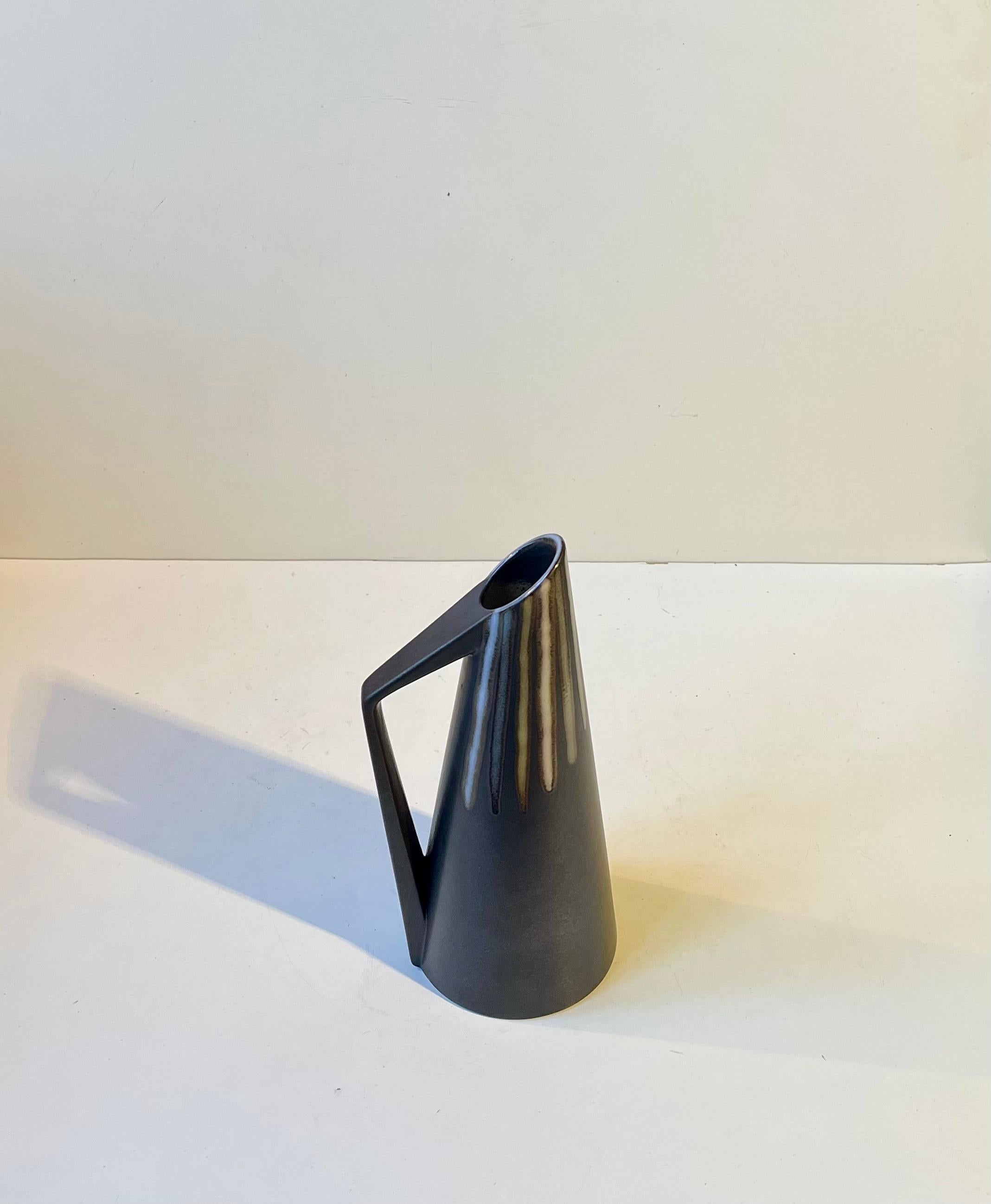 Burgundia Pitcher or vase designed by Svend Aage Holm-Sorensen. Black main glaze with pastel striped decor by Svend Aage Jensen. Manufactured by Søholm in Denmark from 1956-67. Nice intact vintage condition. 
Fully marked and numbered to the