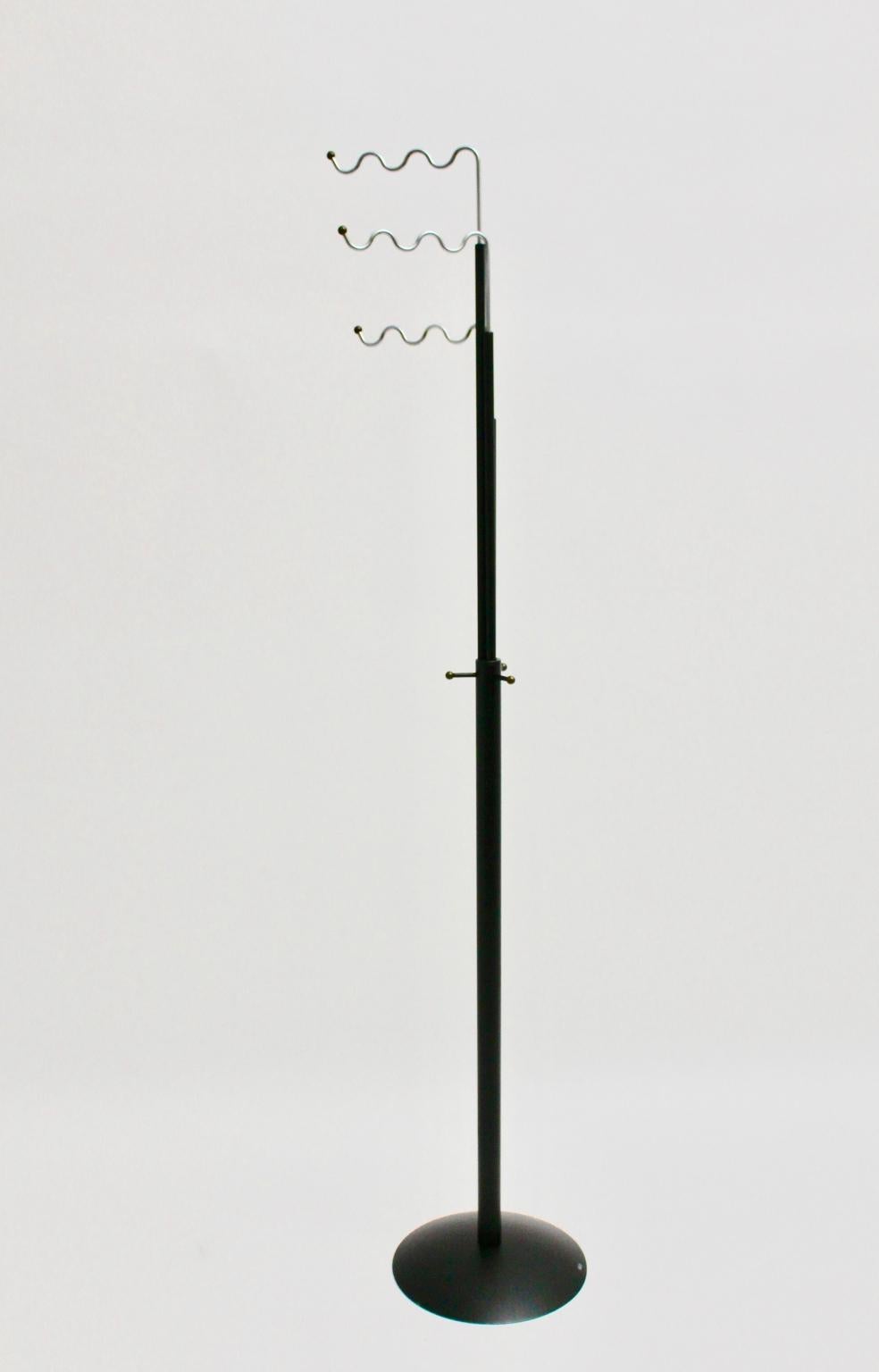 This vintage Scandinavian Modern coat stand by Markus Börgens, 1980s Denmark, and executed by D-Tec, Germany consists of black lacquered metal and three swiveling chromed waves for the clothes. Furthermore the coat Stand shows also three small hooks