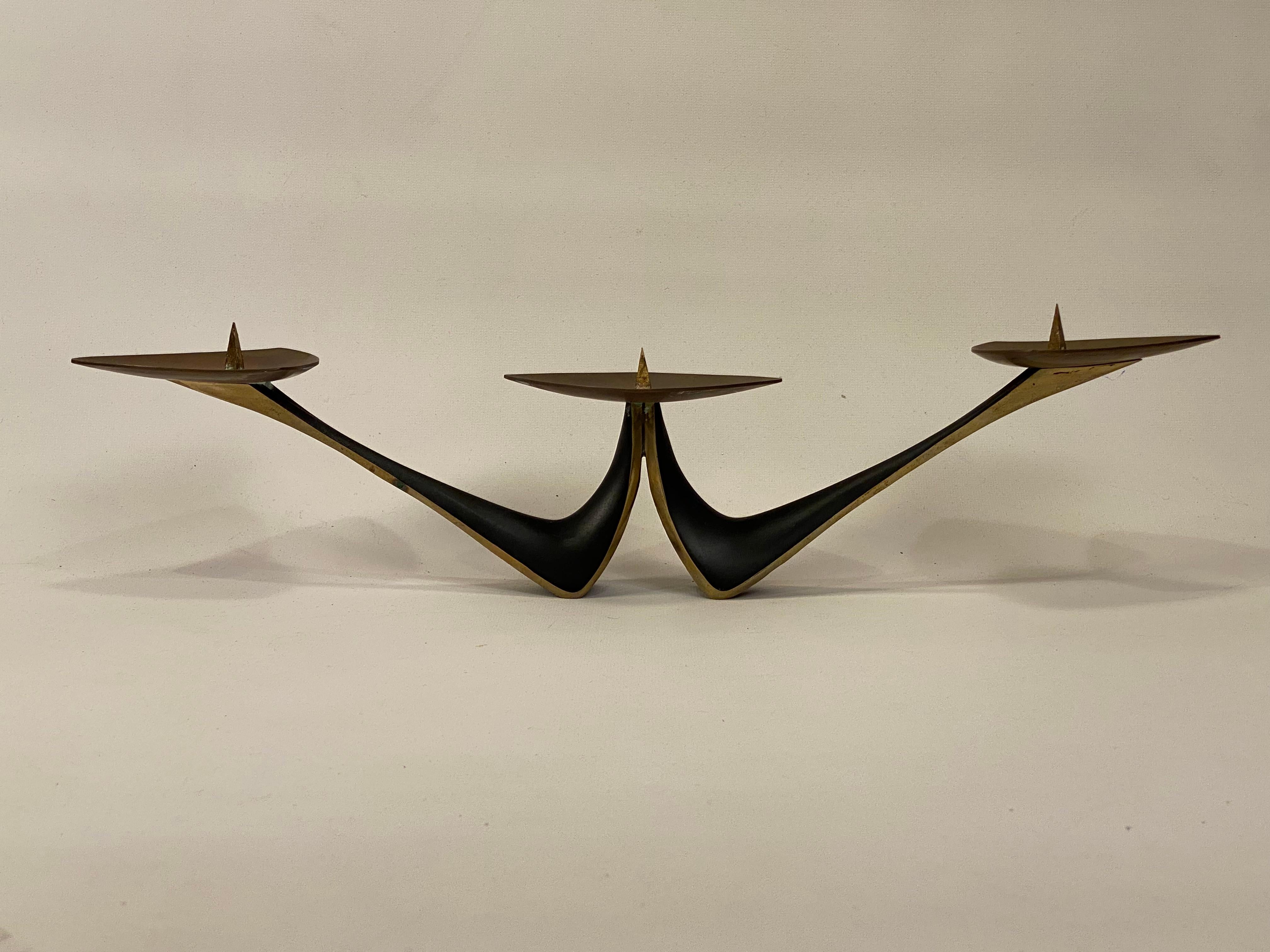 Wonderful modernist solid blackened brass three light candleholder. Circa 1960. Possibly Austrian in origin. Good overall condition with some light tarnish to the un-blackened portions. Wear commensurate with age and use.

Approximately 3