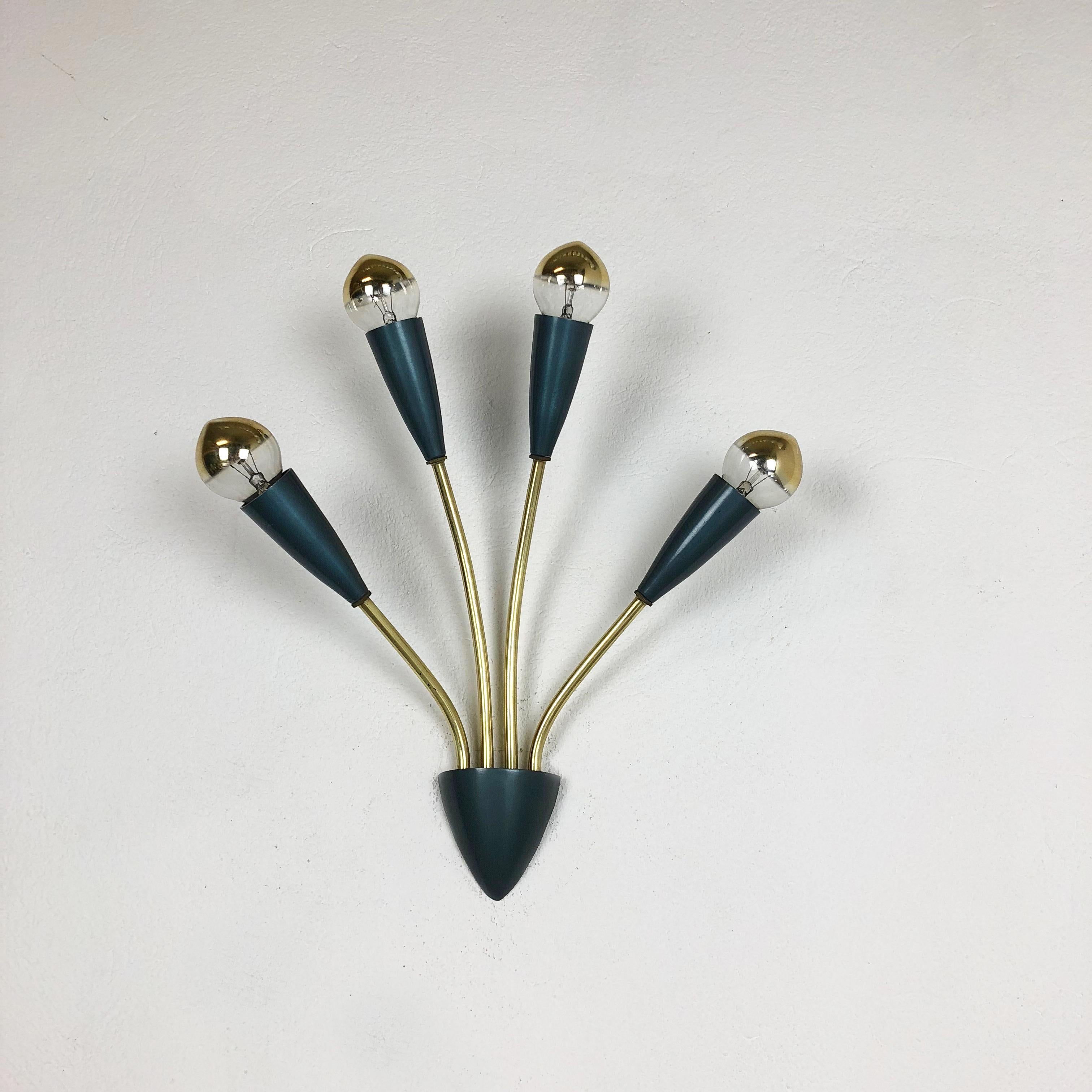 Article:

wall light


Producer:

Origin Italy



Age:

1950s




This modernist wall light was produced in Italy in the 1950s. It is made from solid metal with brass tone finish on the four light arms and socket elements and wall